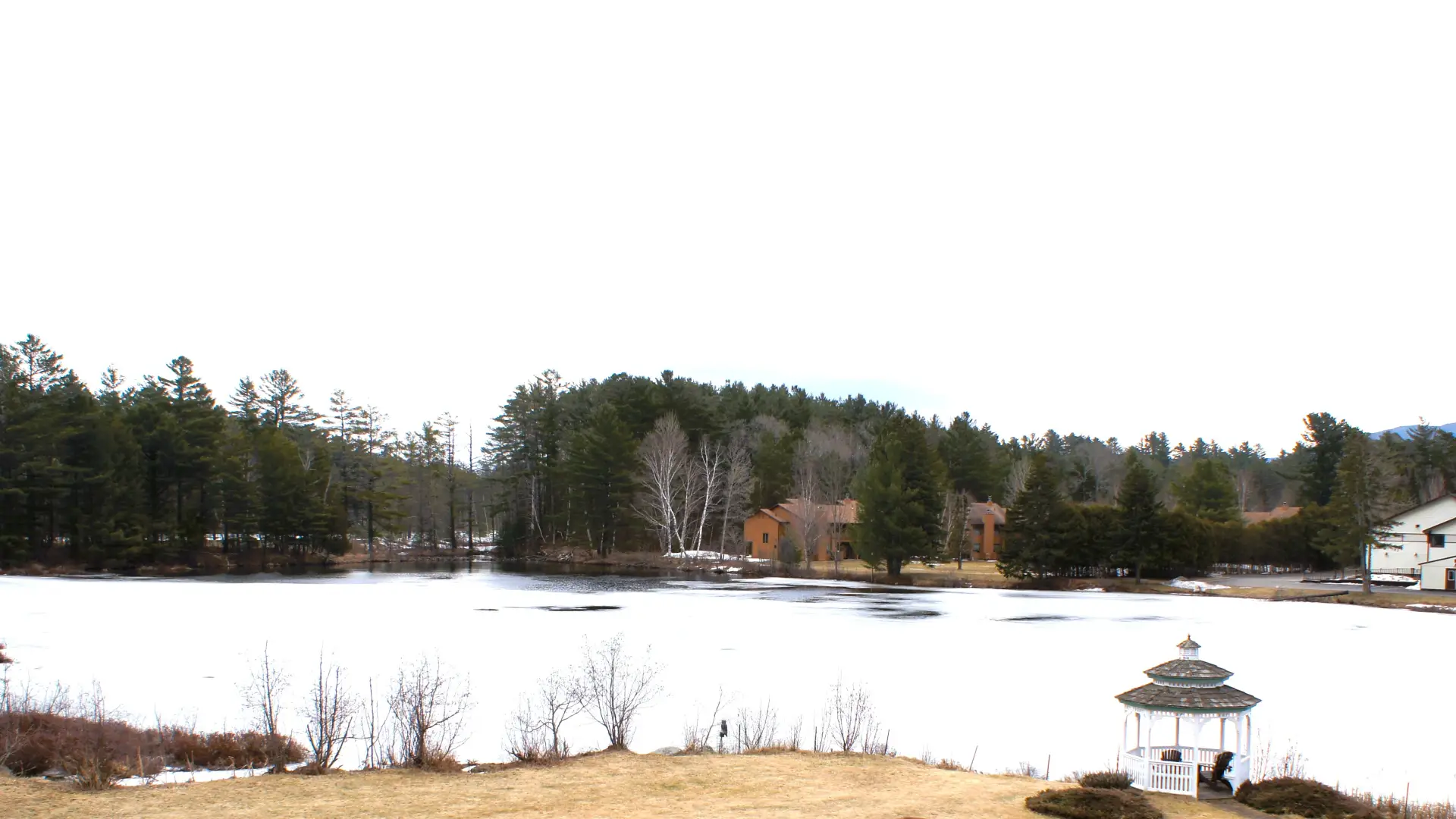 The snow covered pond by Sara Placid Inn & Suites.