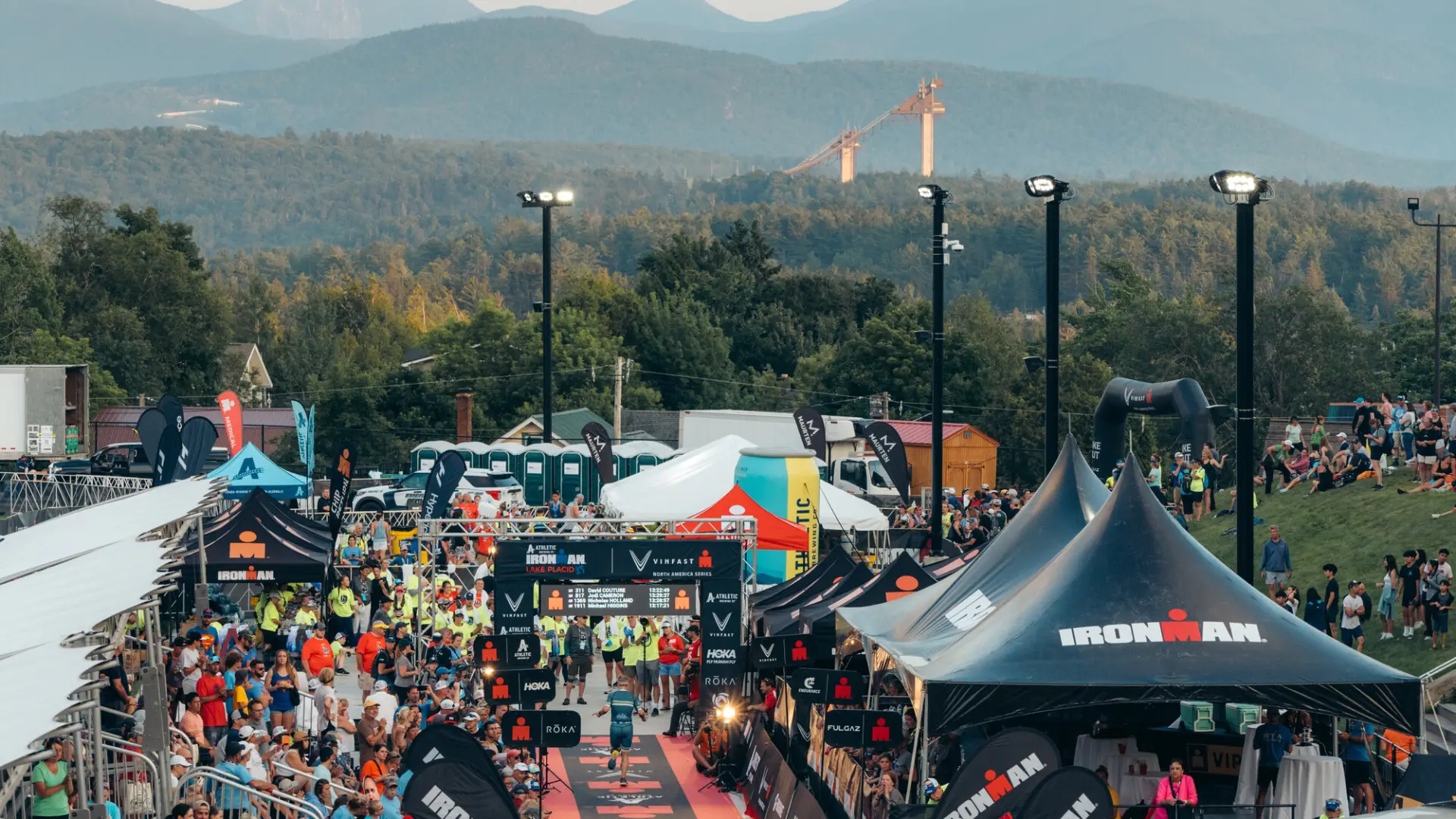 Ironman Lake Placid Finish line with ski jumps and mountains in background