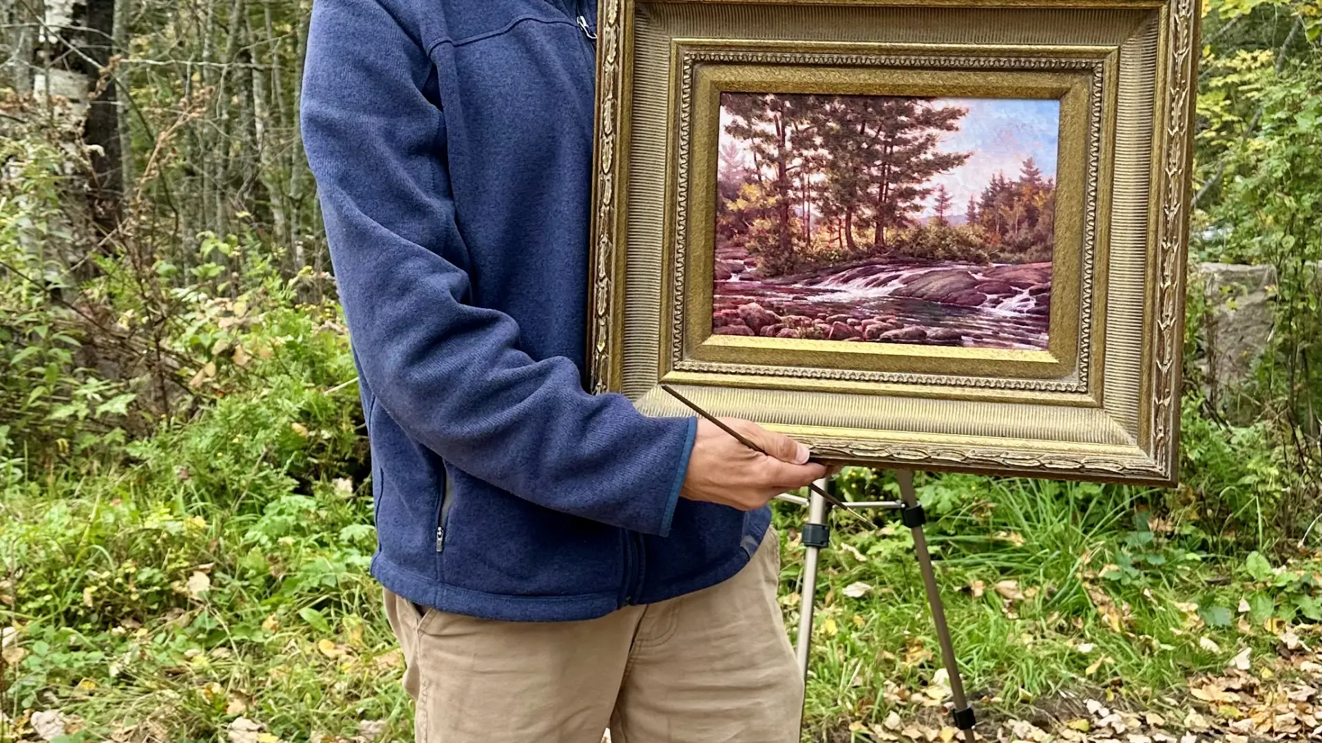 artist holding frame