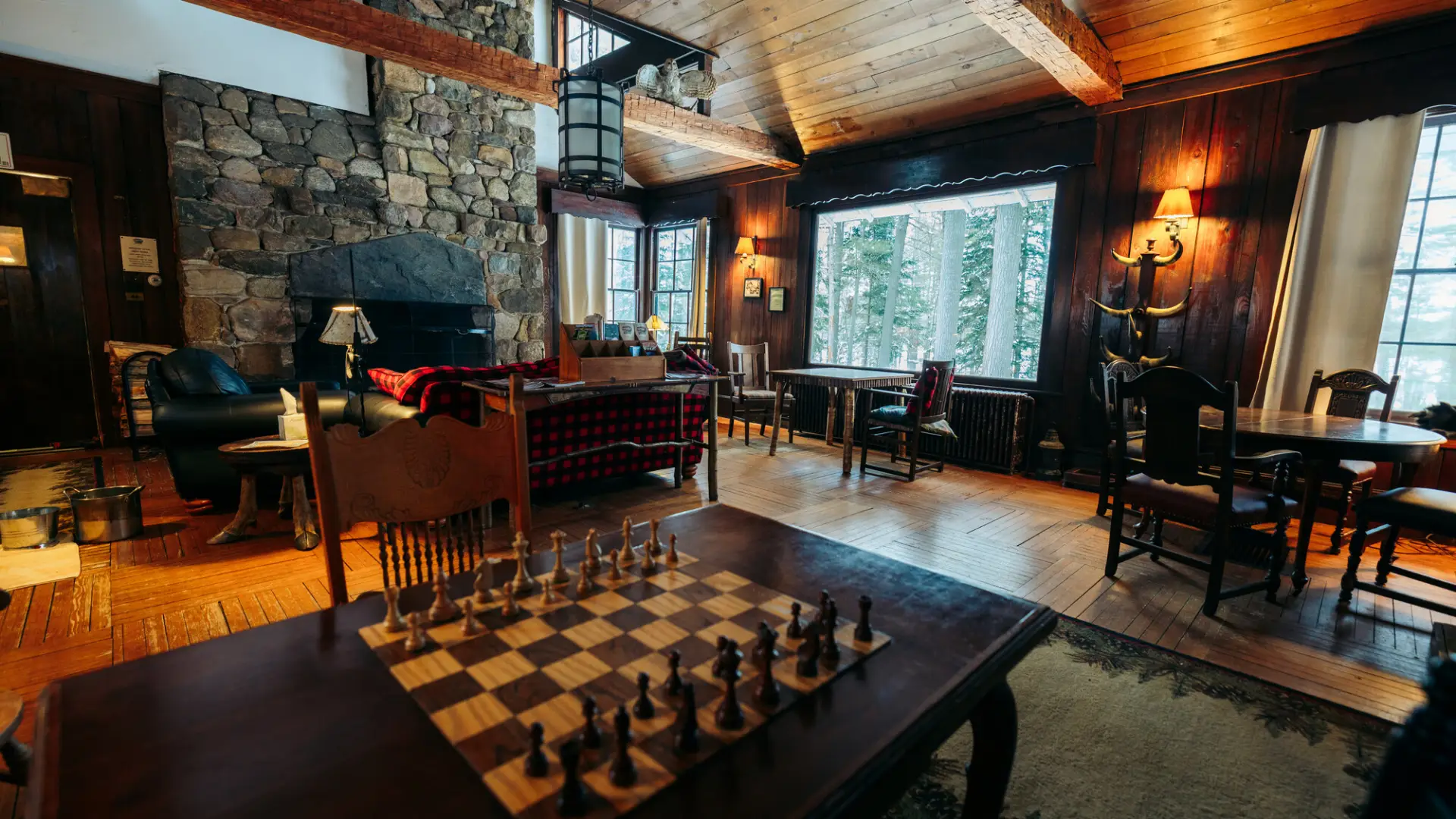 A grand lodge bedroom with a chess board and wood finishings.
