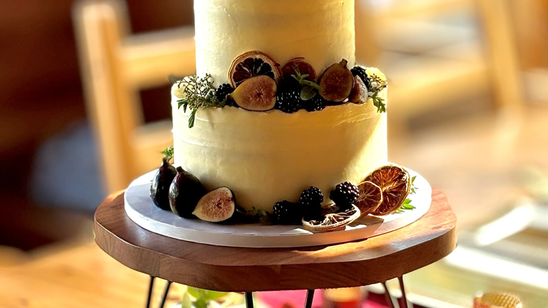 A two tiered cake decorated with dried fruits.