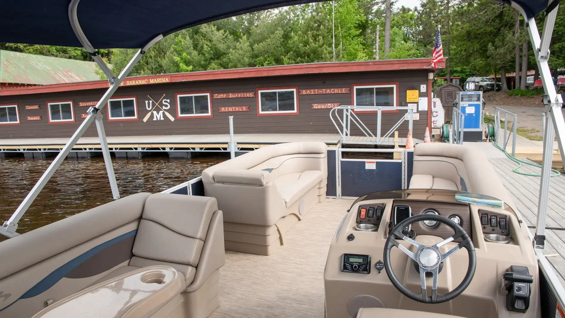 inside view of pontoon boat rental with marina rental cabin in the background
