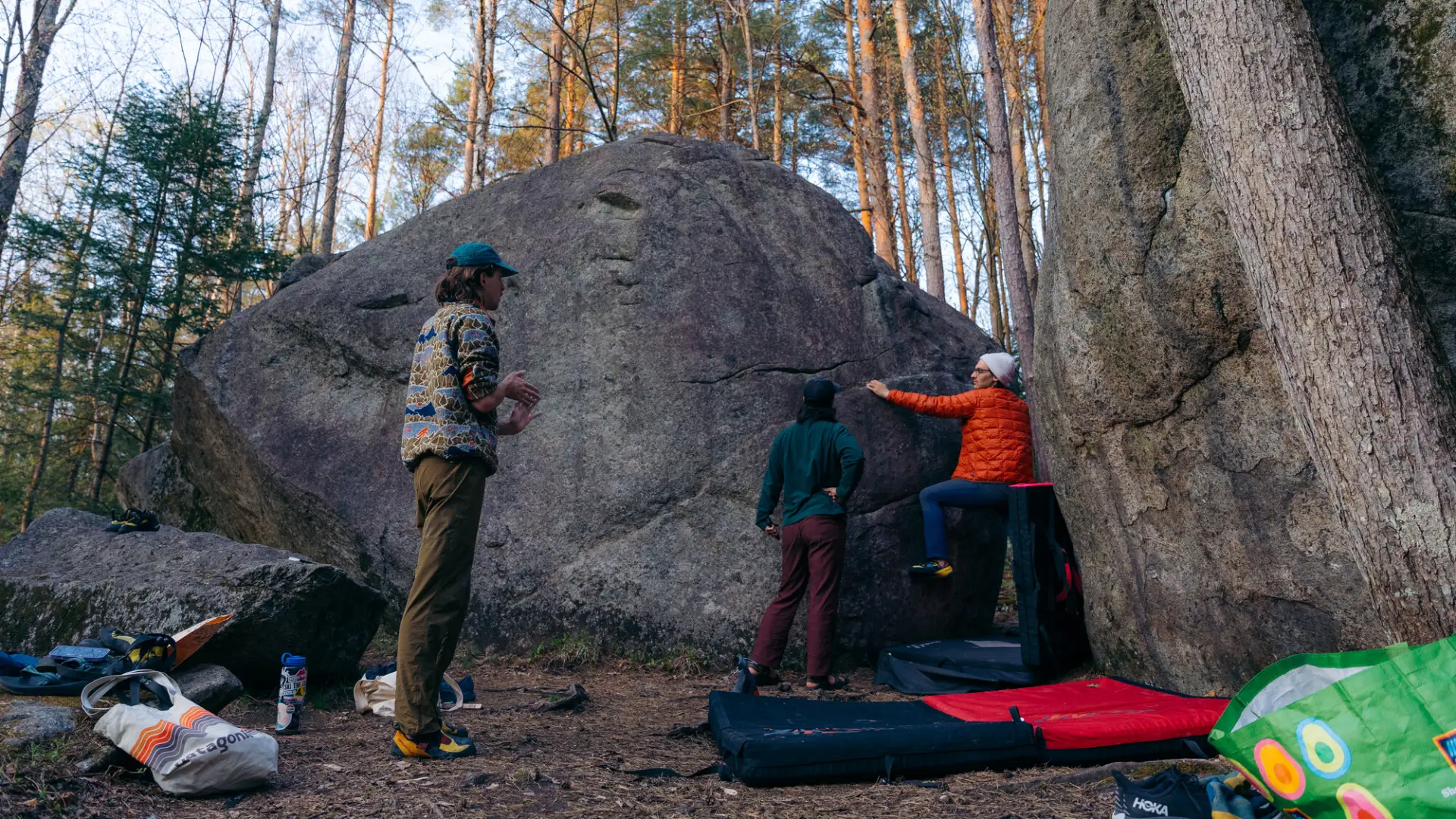 A group of bouderers working on a problem