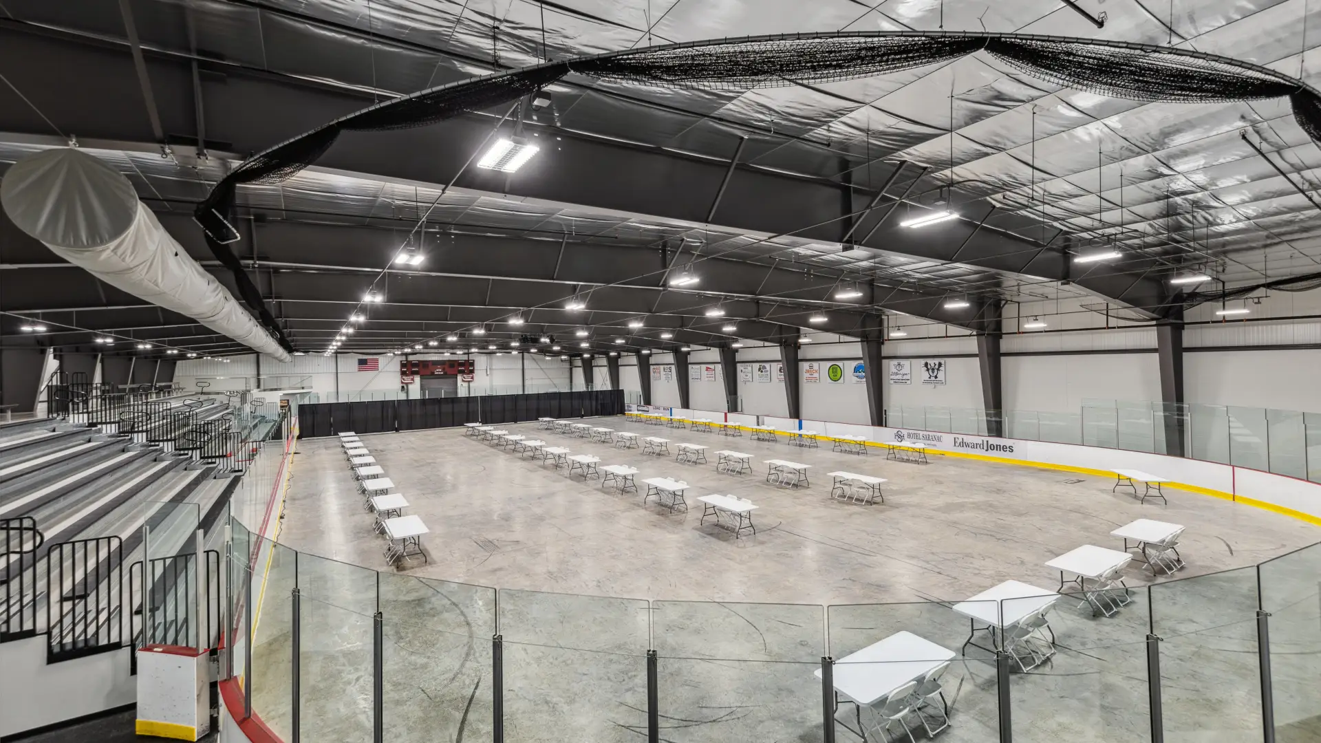 The de-iced rink at the Saranac Lake Civic Center set up with tables for an expo.