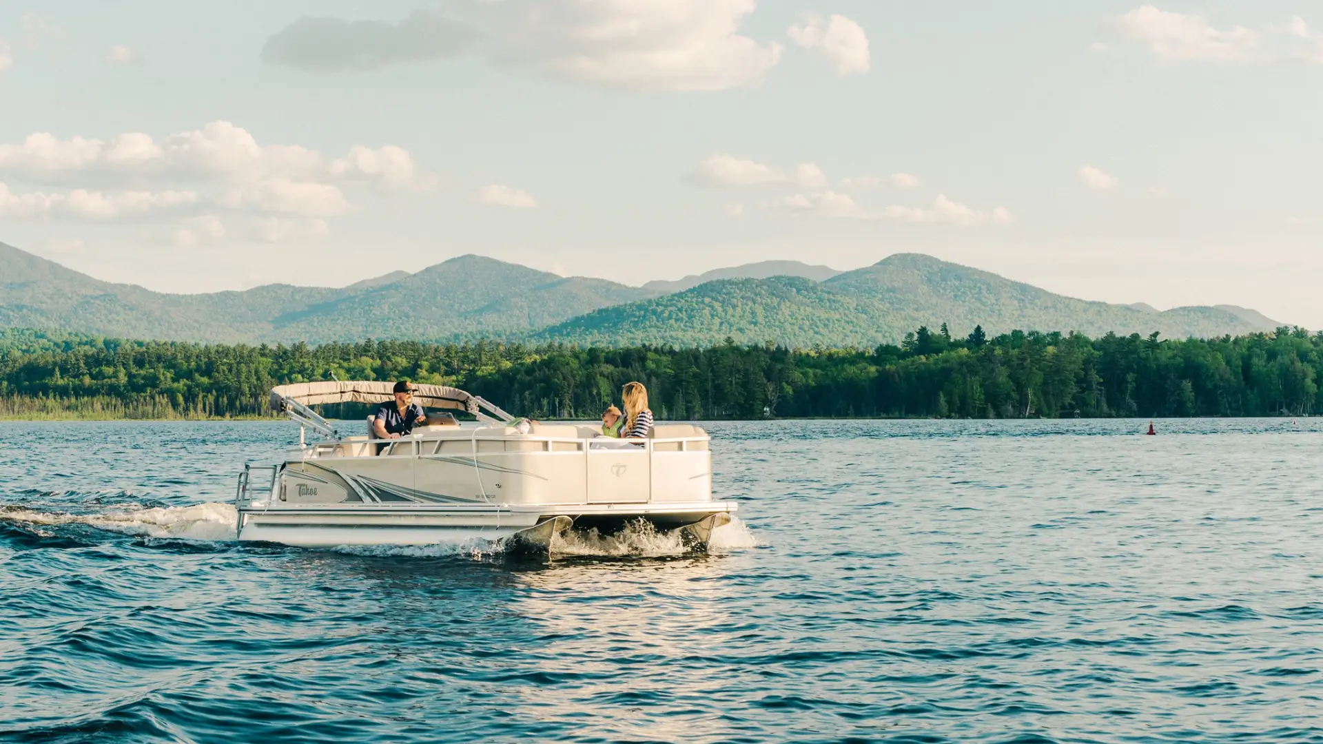 A family on a boat near Saranac Lake