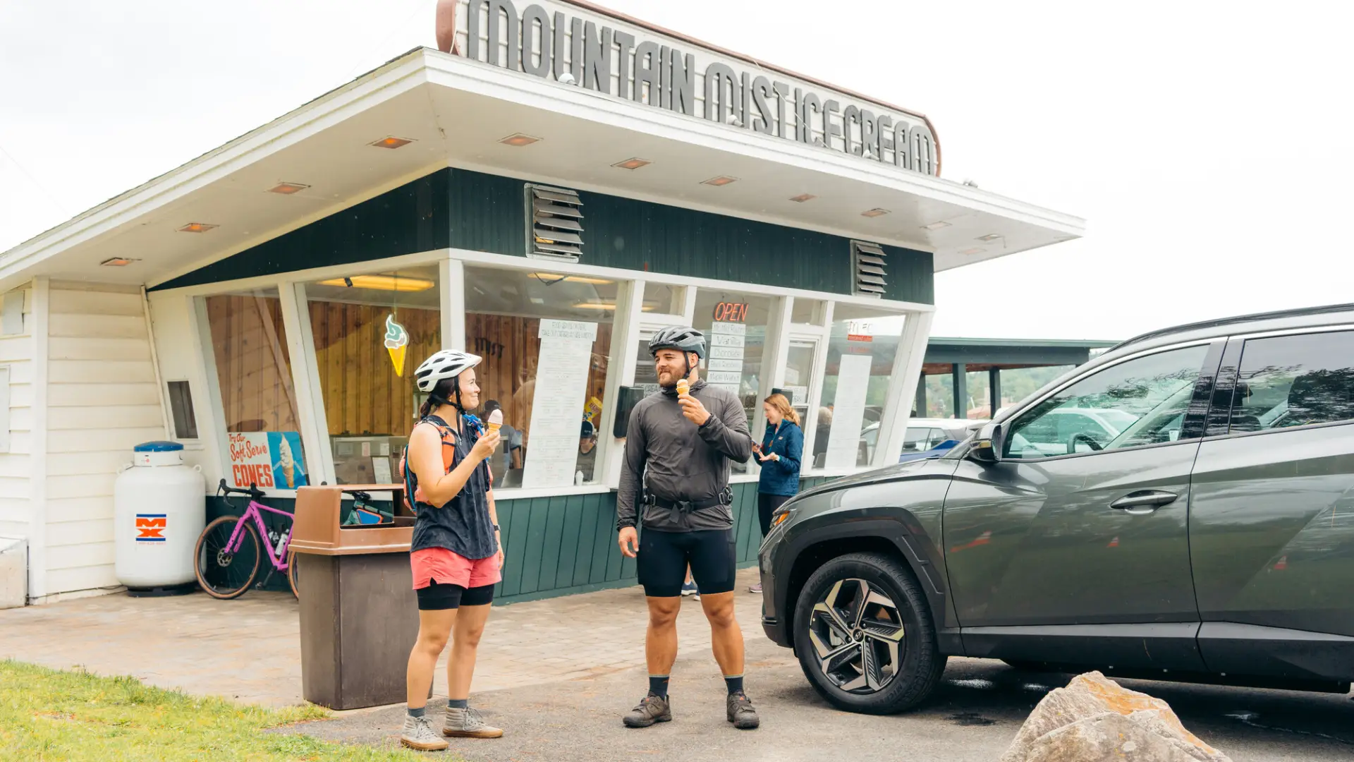 cyclists enjoying ice cream cones outside mountain mist