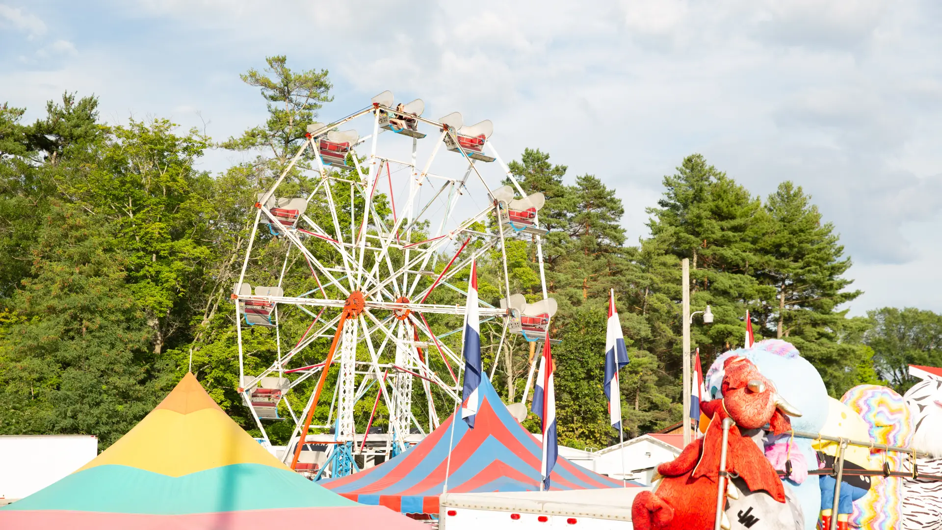 A ferris wheel above colorful tents
