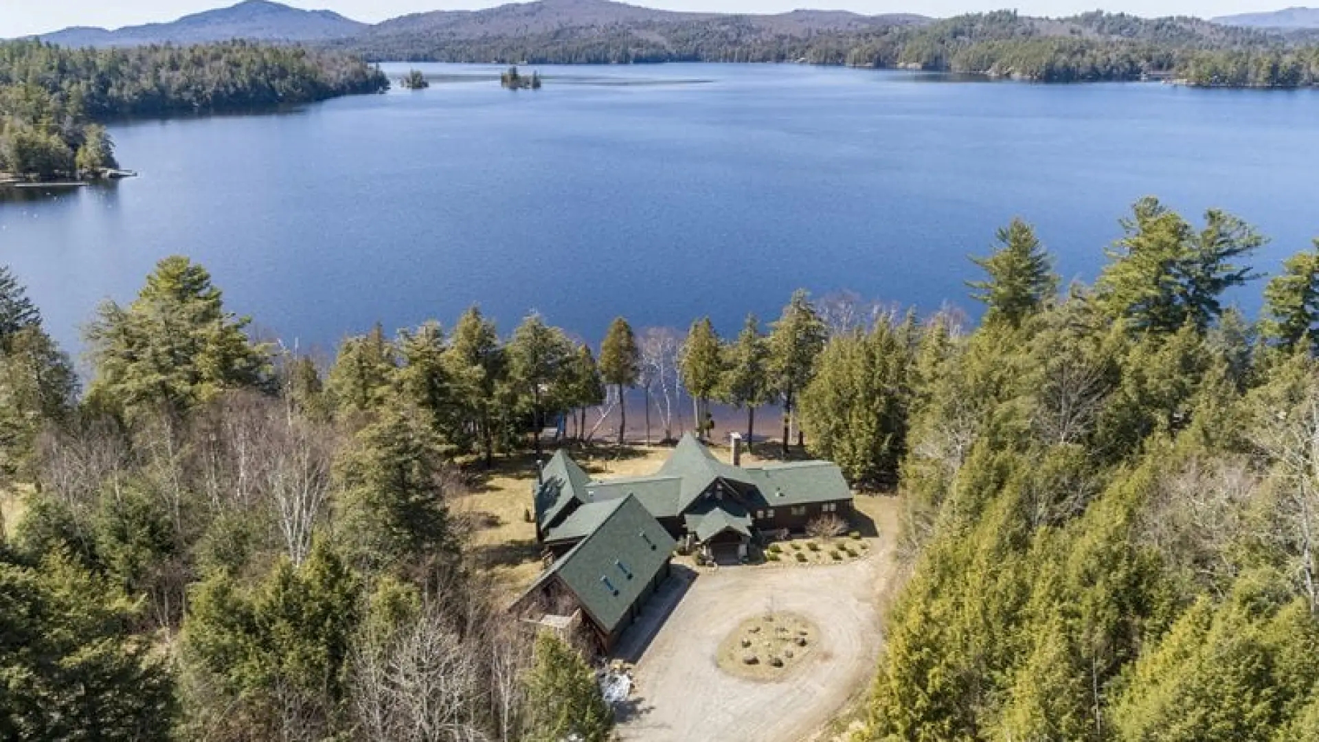 An aerial view of Alpenglow Lakeside Lodge showing the prominence of the building and the proximity to the water.