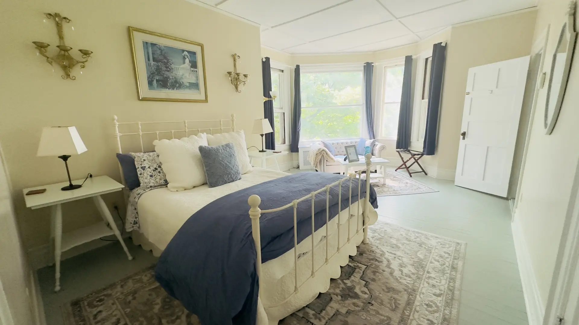 A large bay window beckons you into the room past a large lux bed 
