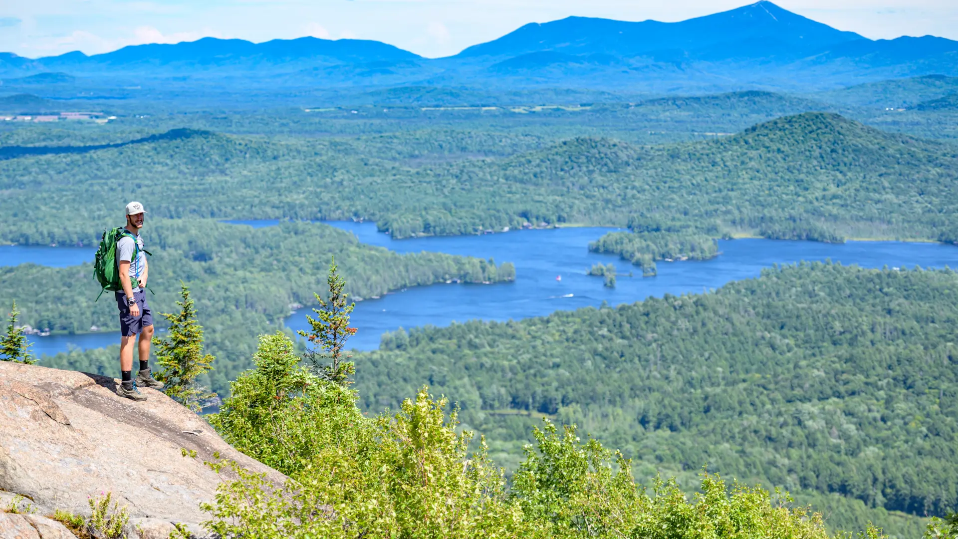 A man standing on the summit of St Regis Mountain