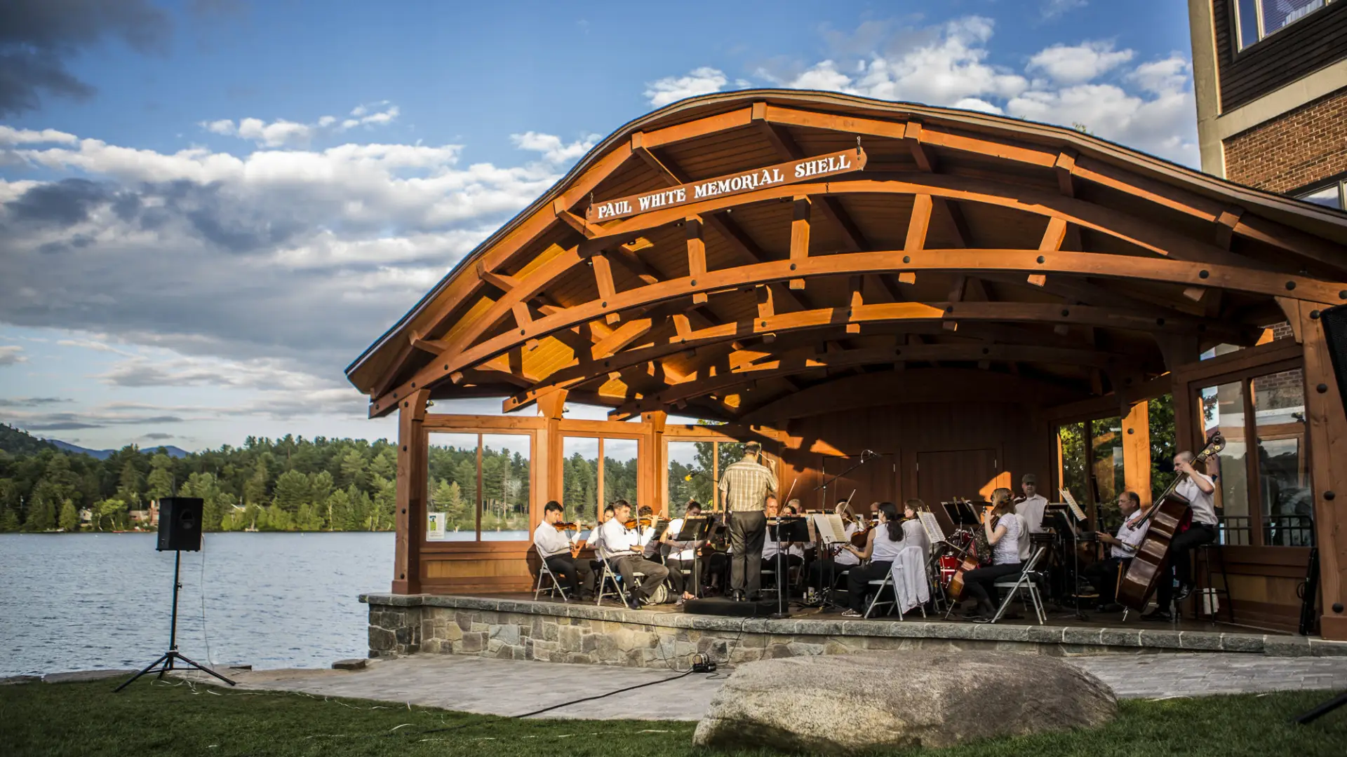 Sinfonietta playing in a lakeside bandshell on a summer day