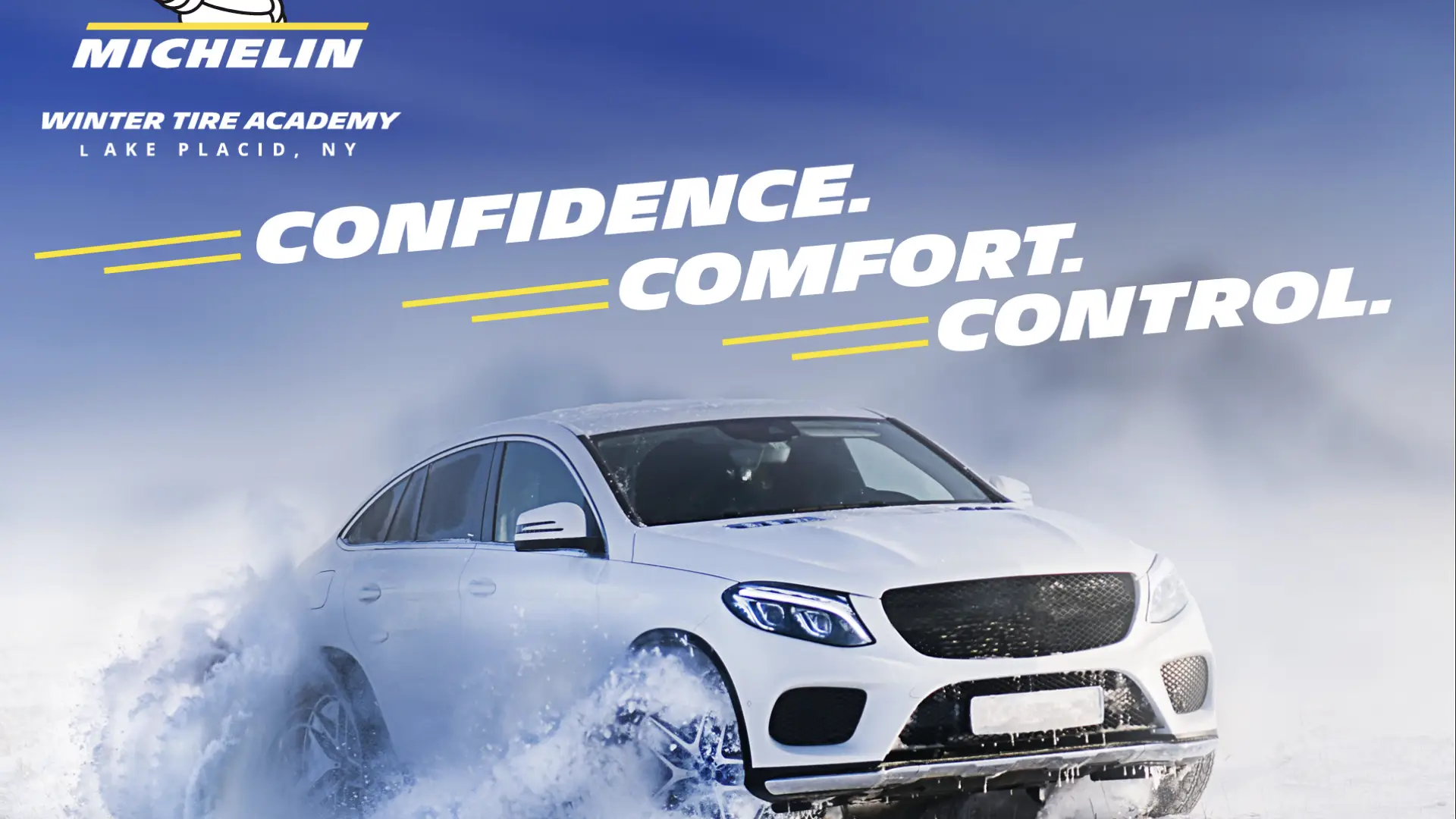 White sedan drives in snow with Michelin logo and the words Confidence, comfort, and control above it against blue sky