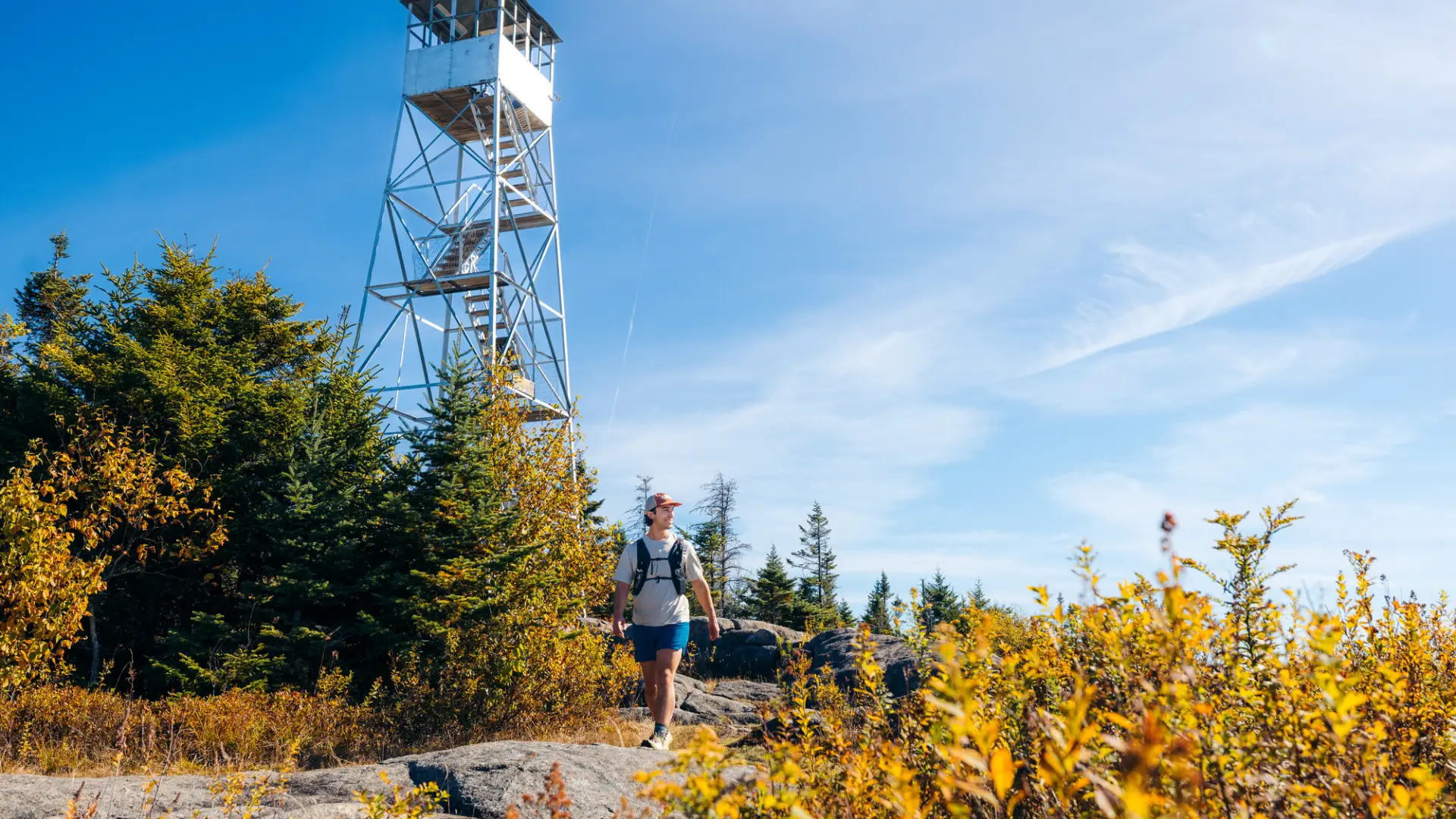The view of a hiker in front of a fire tower