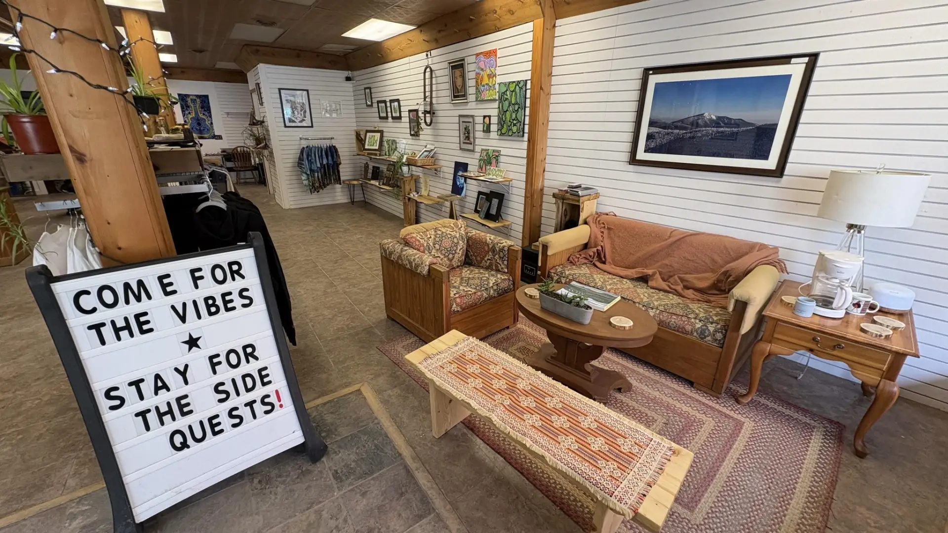 An open space with art on the walls, and a comfy seating area