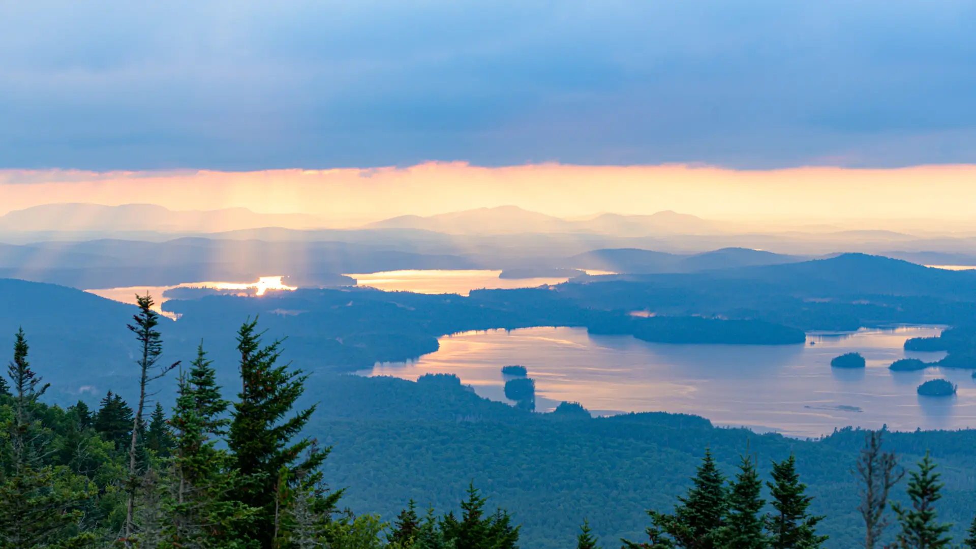 Stunning view of the reflection of the sunrise in a lake from the top of Ampersand Mountain