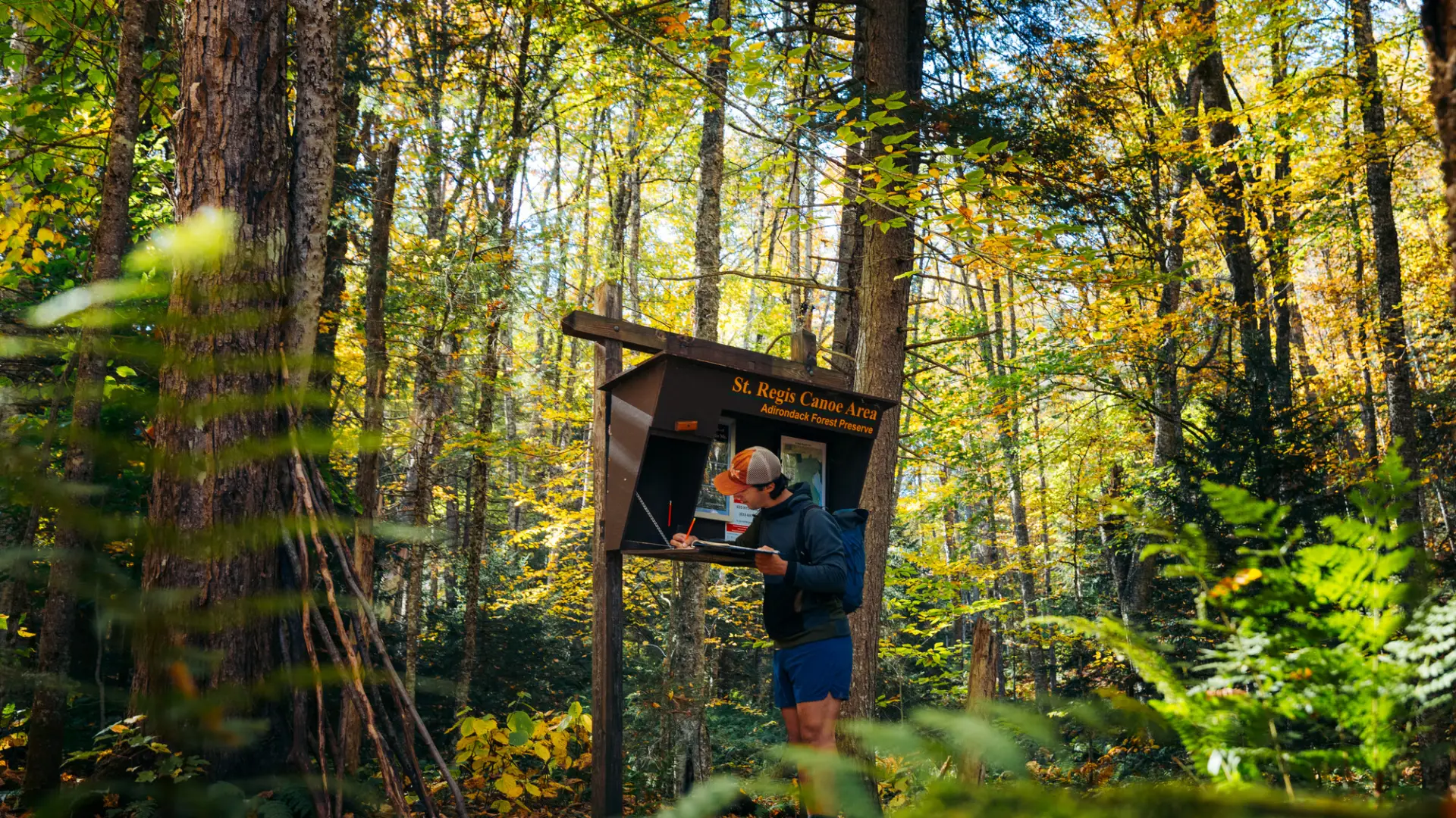 A hiker signing into the register for a mountain