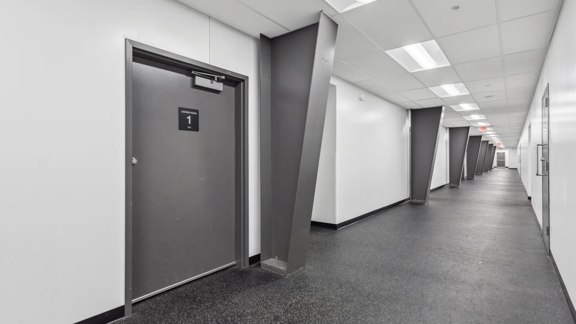 A long hallway with the entry way to the locker rooms.