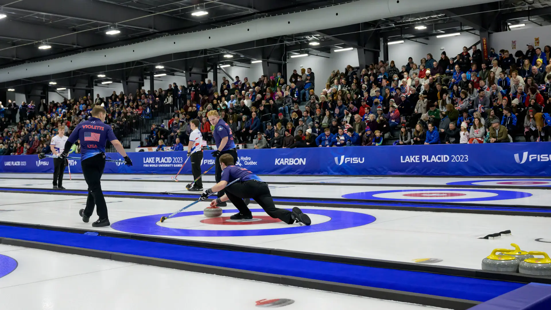 People curling on the ice of the rink at the Saranac Lake Civic Center.