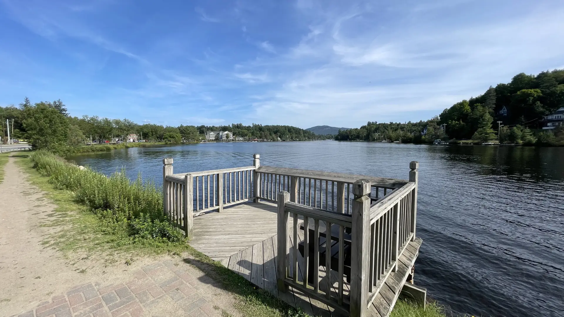 A small deck on the side of a pond