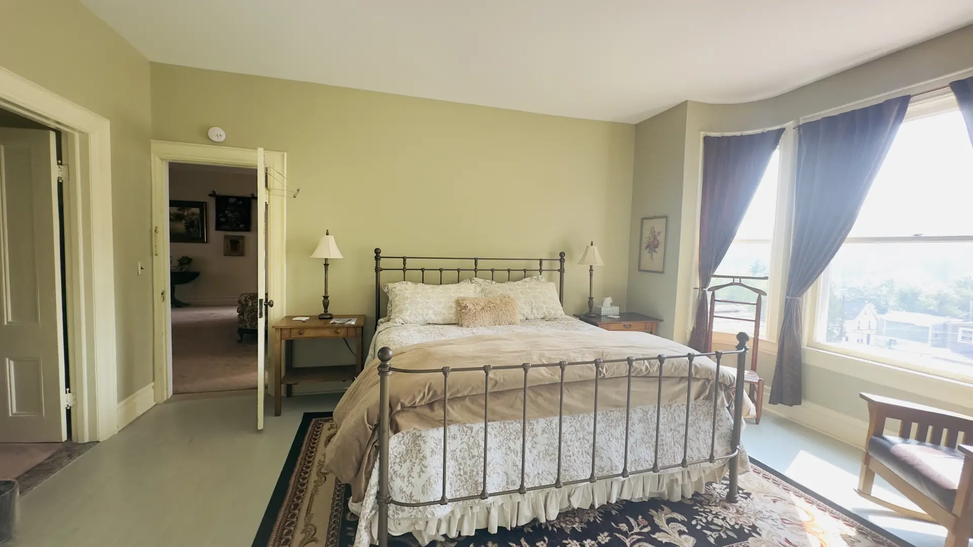 Huge bay windows flood this bedroom with light.