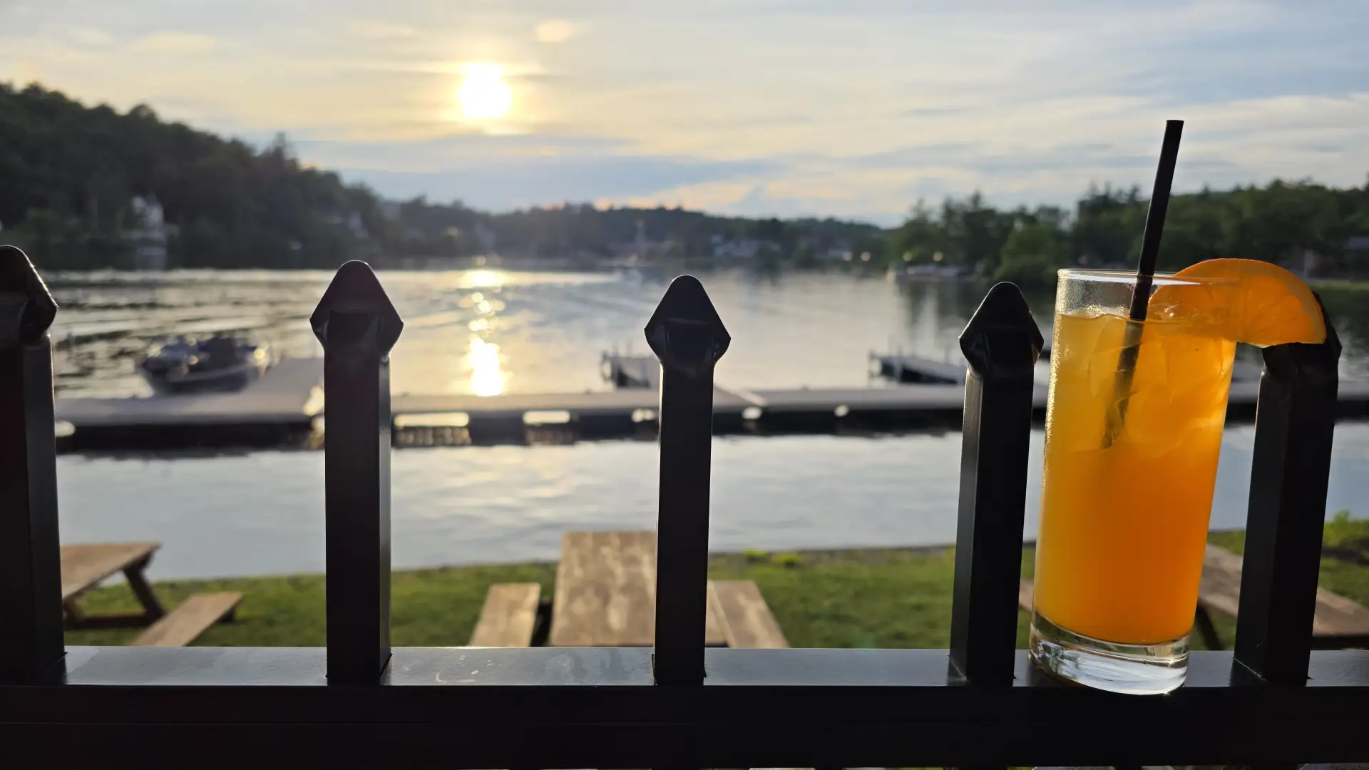 A sunset view of the lake from the patio with a freshly poured beverage