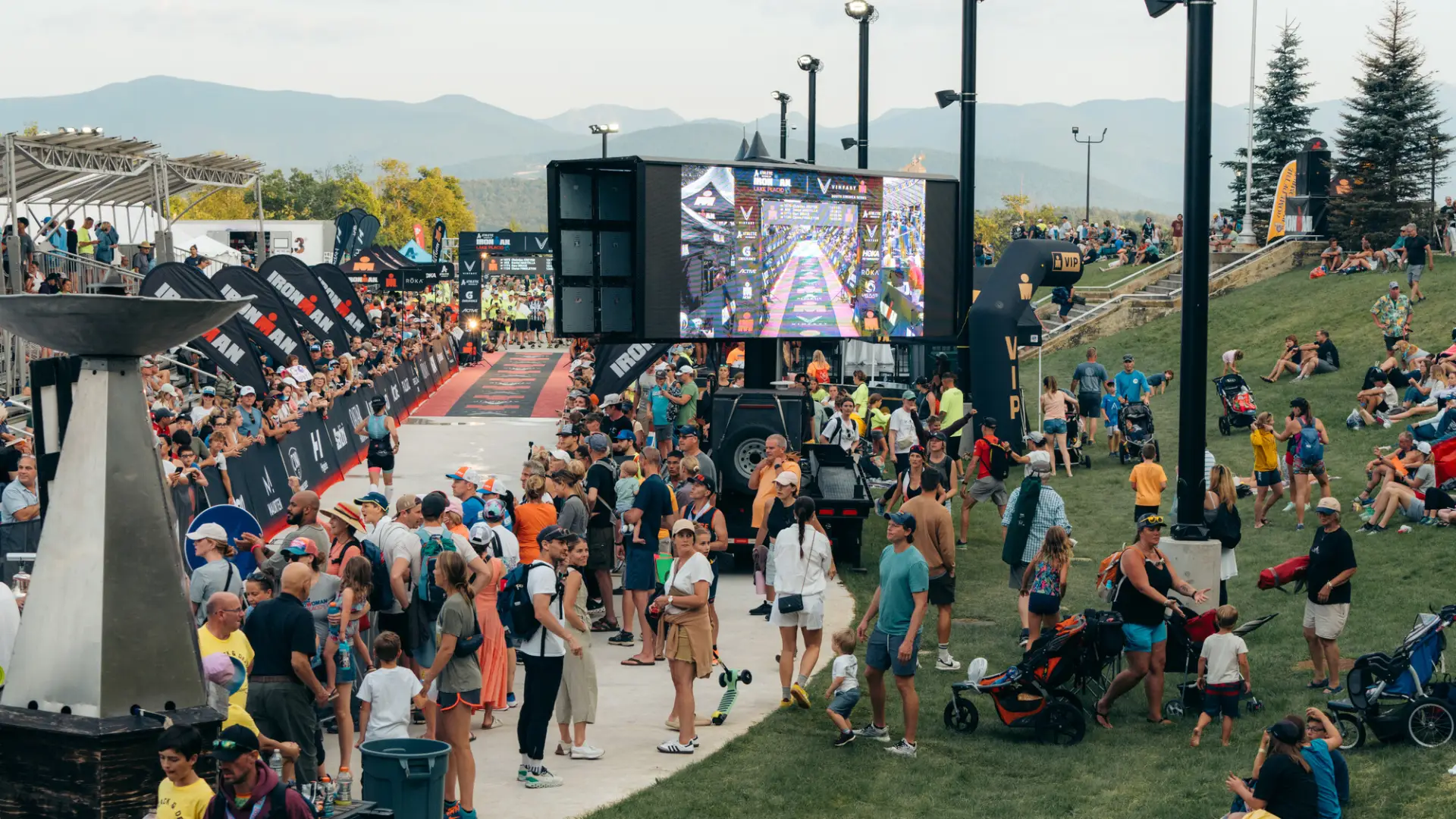 Ironman spectators at finish watching jumbotron