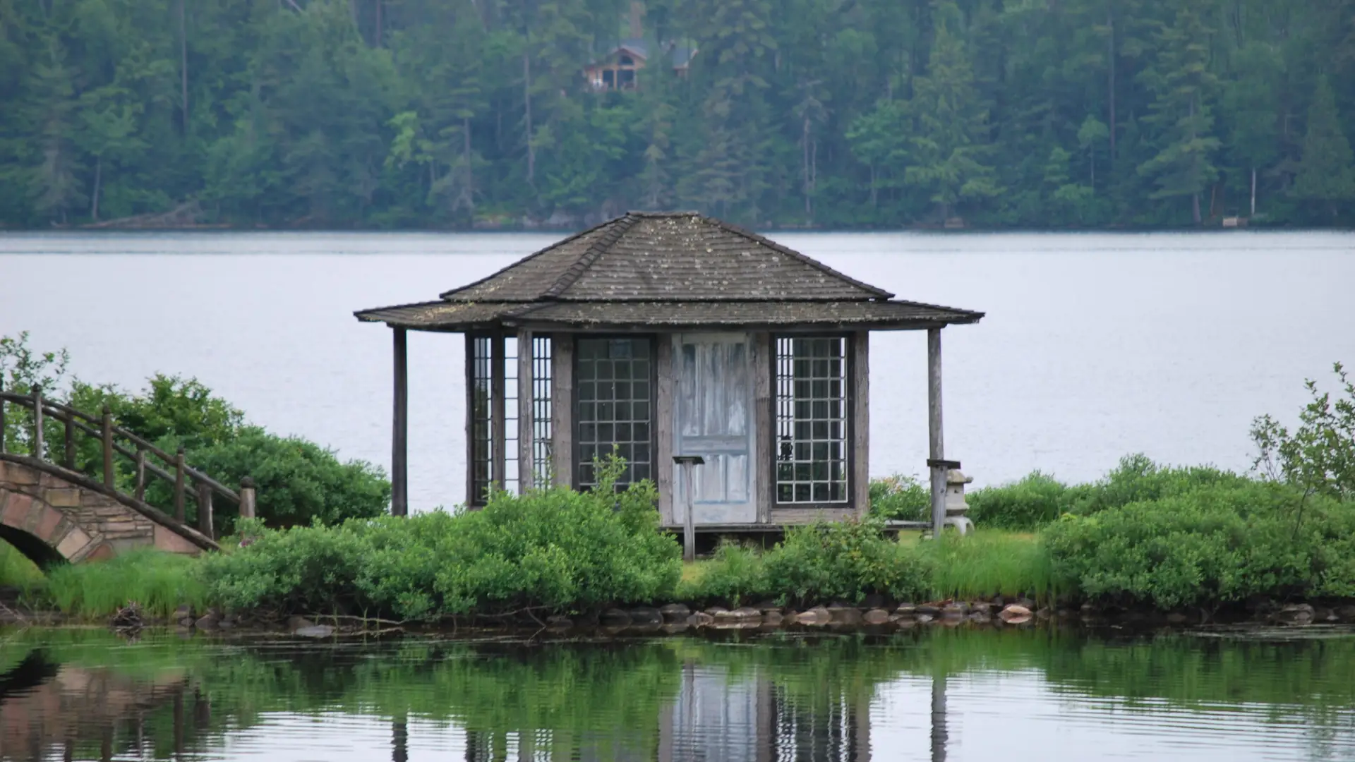 An old tea house on a narrow strip of land in a pond