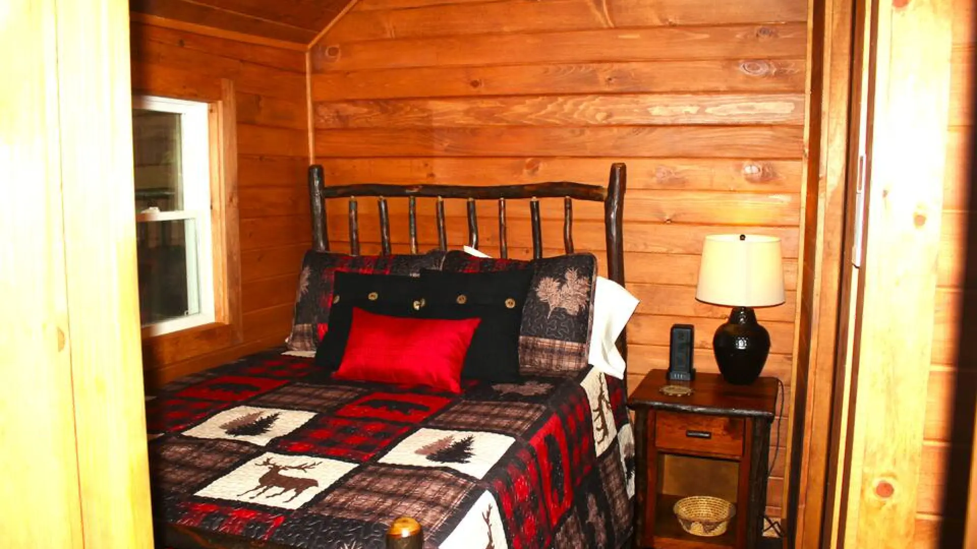 Rustic bedding in the cozy sleeping space at Rockledge Cabins & Retreats 