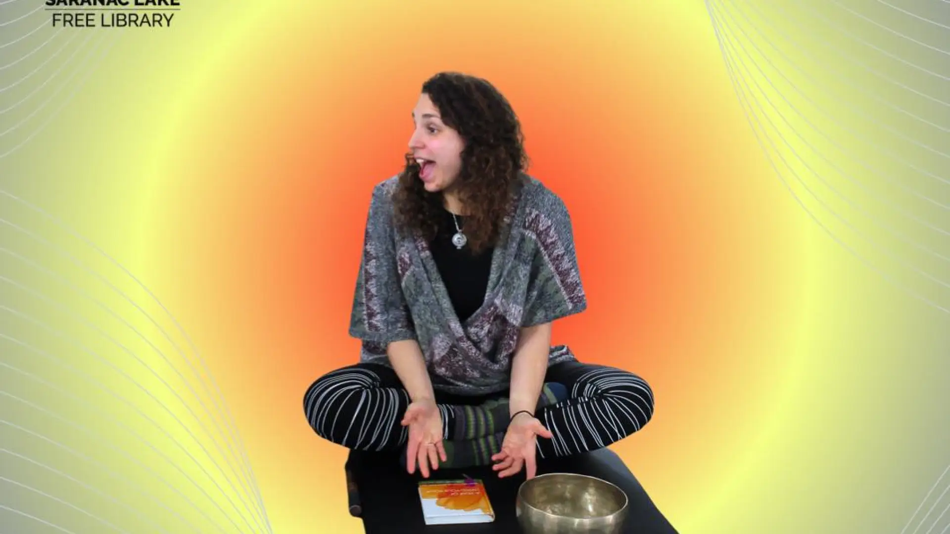 A happy and energetic woman sits on a yoga mat with the words ' Community Yoga with Elise Phillips"