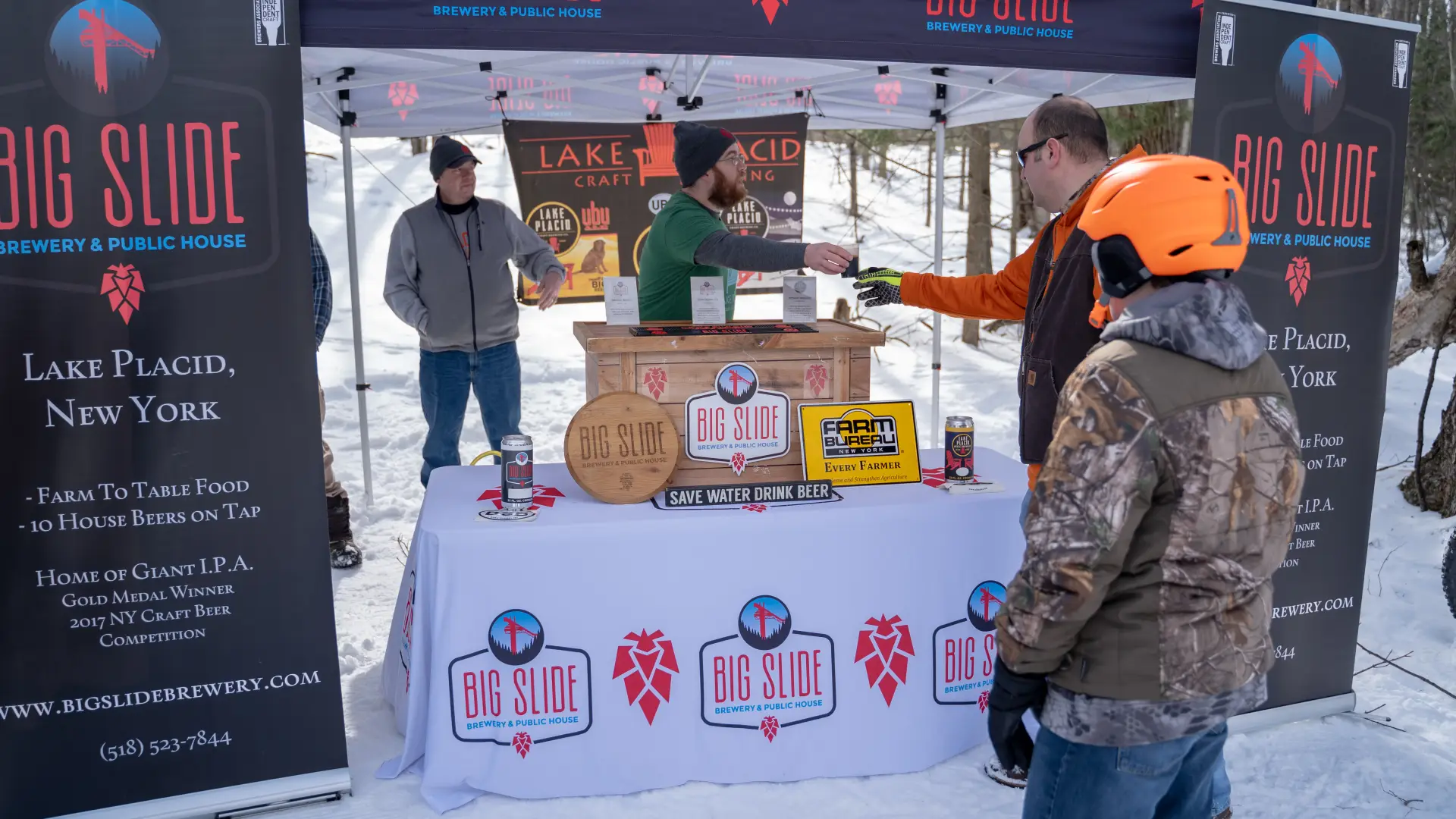 Snowshoers getting Big Slide Brewery beer. 