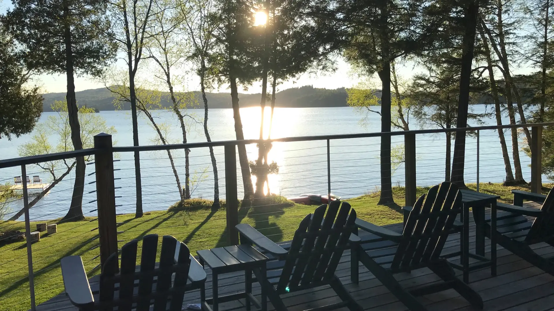A view of the lake from the deck overlooking the expansive lawn at Alpenglow Lakeside Lodge.