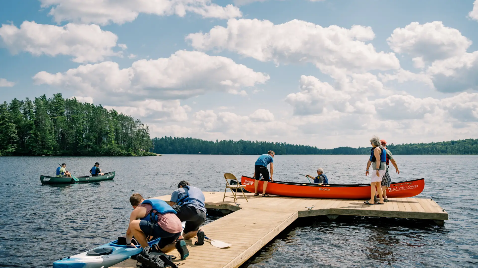 multiple canoes in mountain lake setting 