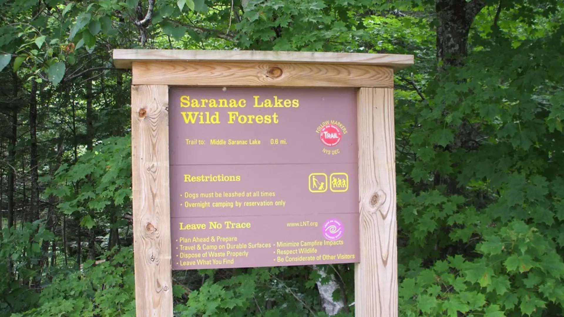 A wooden sign for the Saranac Lakes Wild Forest