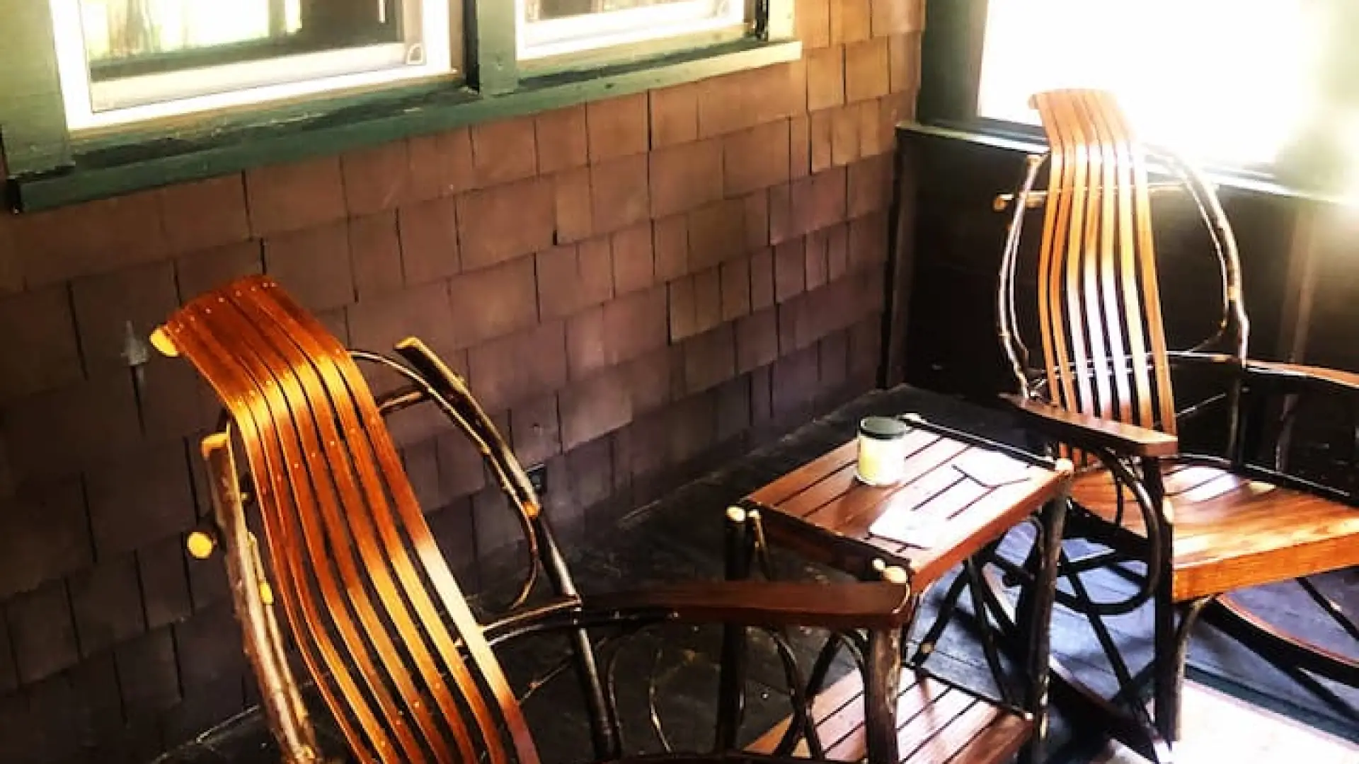 Wooden rocking chairs on the front porch at Rockledge Cabins & Retreats 