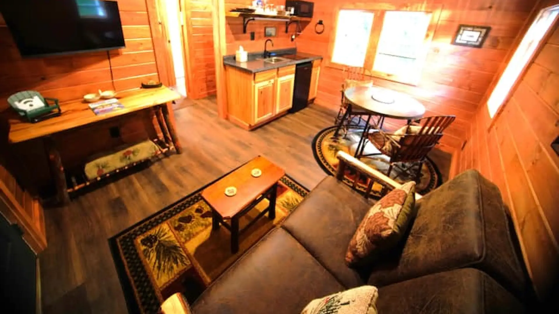 Open living space with dining area and kitchenette at Rockledge Cabins & Retreats 