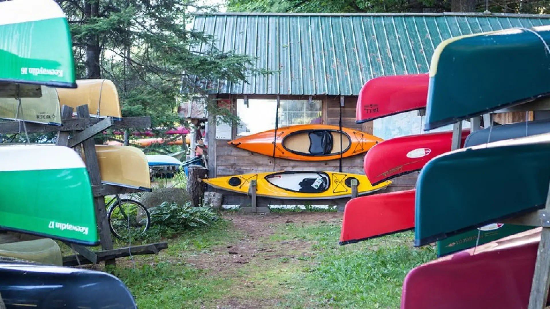 Colorful boats on racks outside.