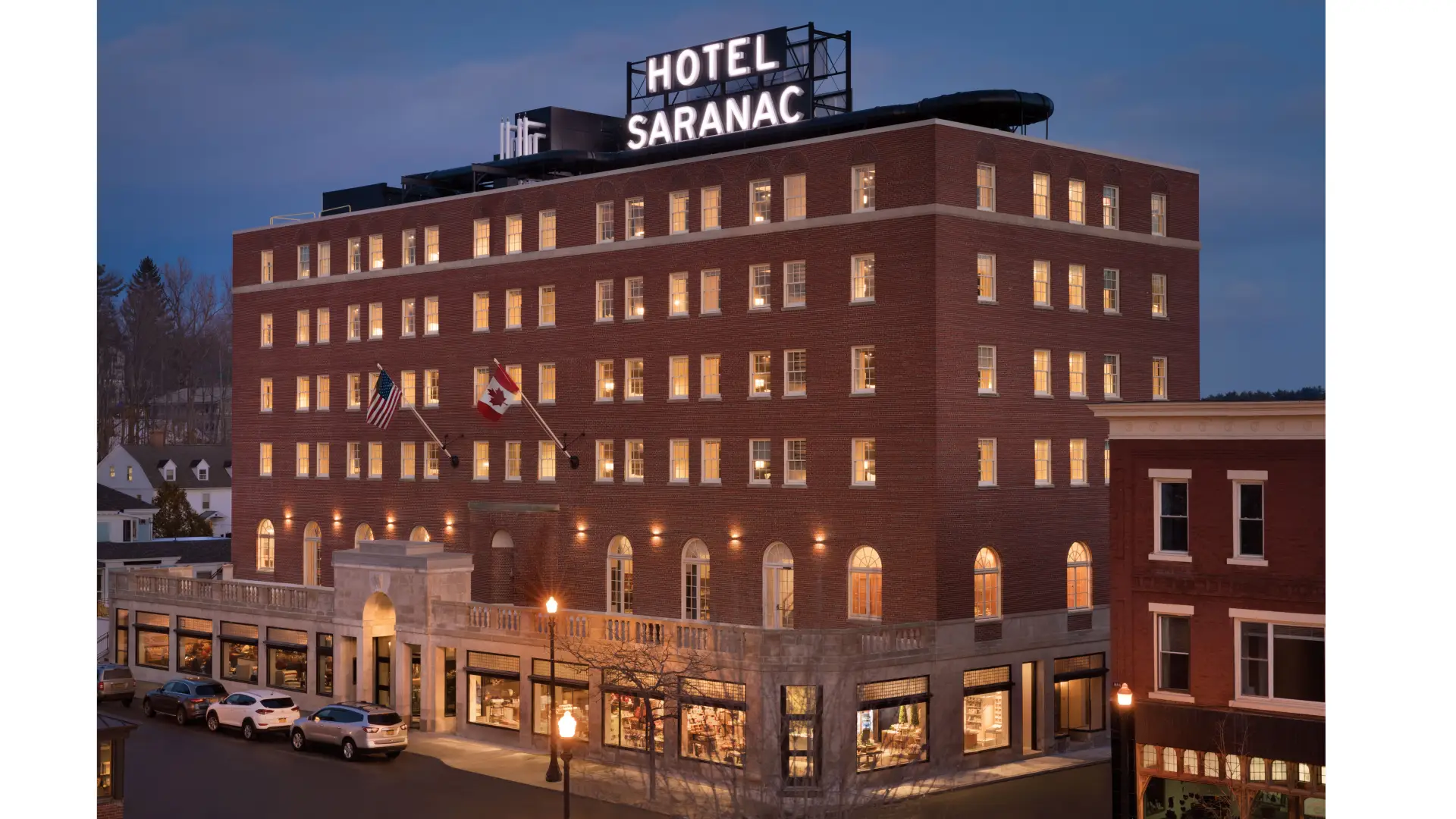 Aerial view of the Hotel Saranac lit up at dusk
