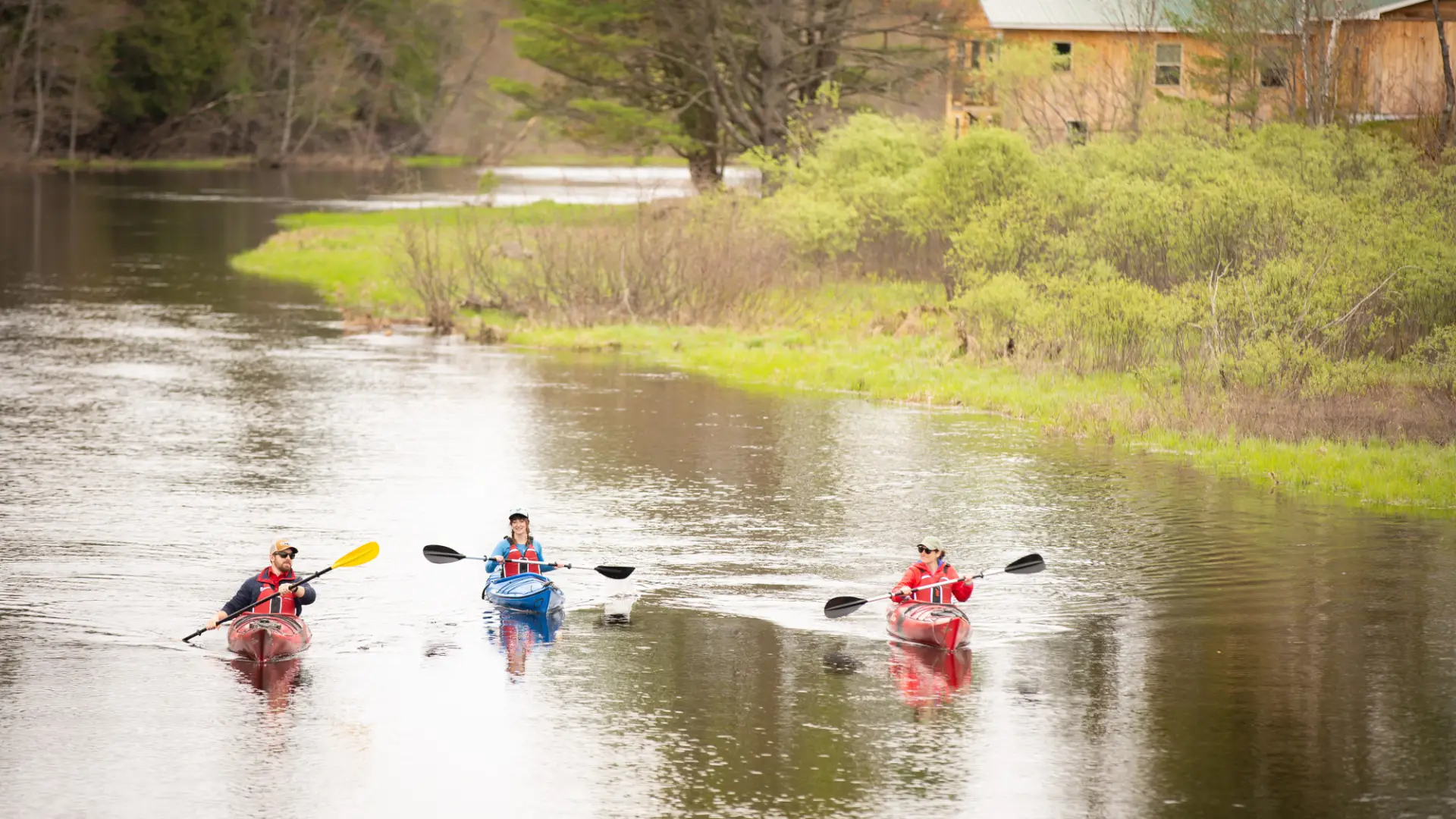 Three paddlers in the Saranac River