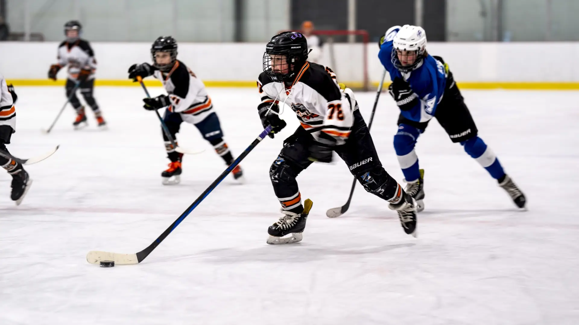 Youth hockey players in action on the ice, showcasing teamwork and skill.