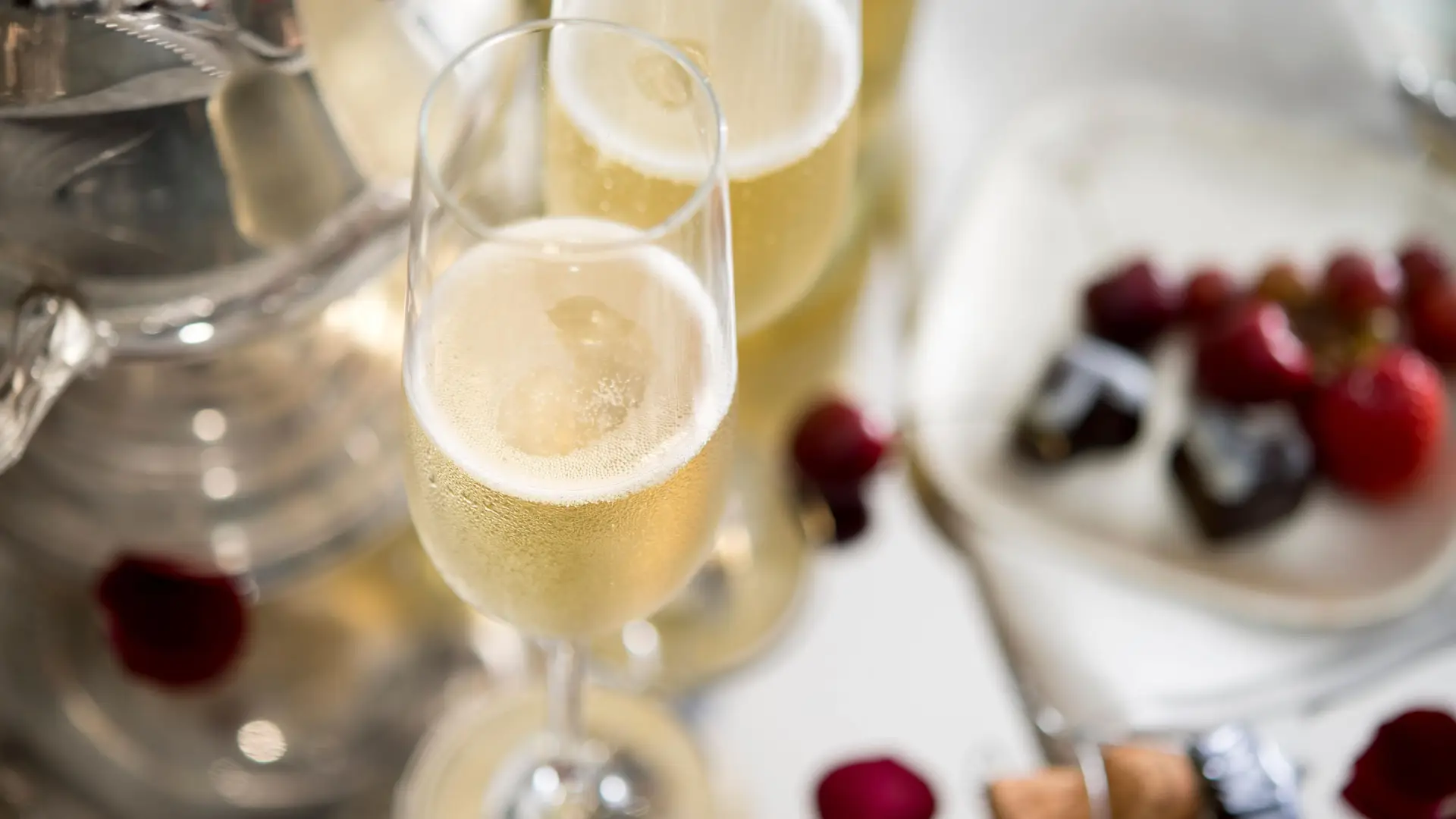 Champagne in flutes with scattered berries