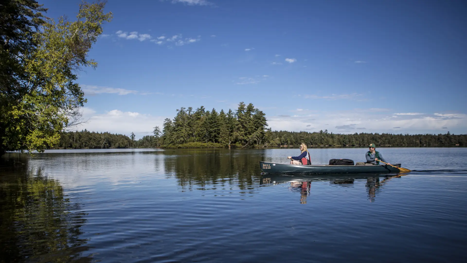 Two paddlers in a canoe on calm waters