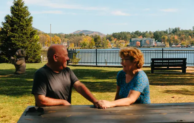 A couple at a Saranac Lake park in the fall.