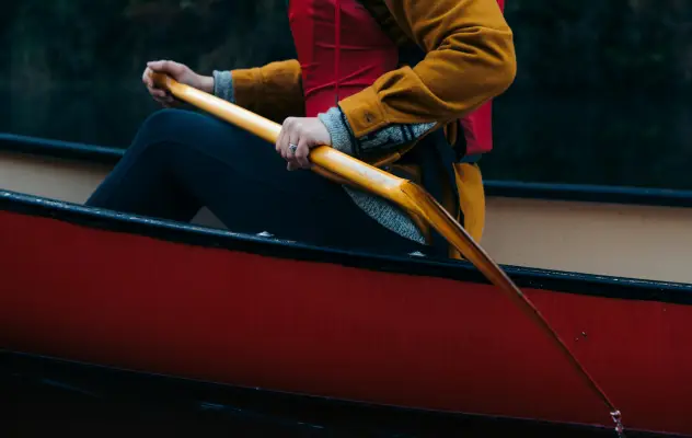Paddling in a boat.