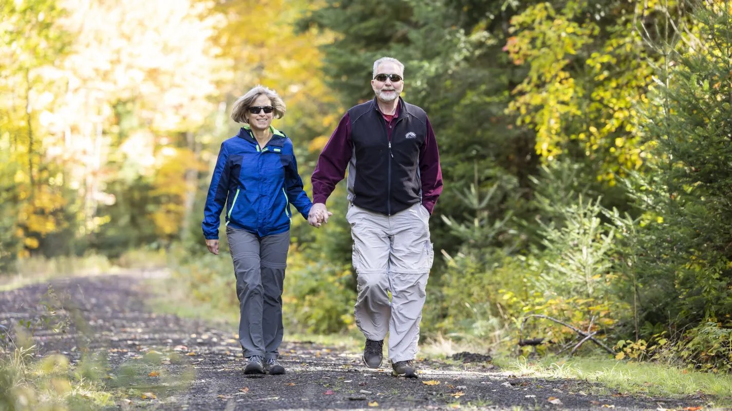 A couple going for a walk in Saranac Lake.