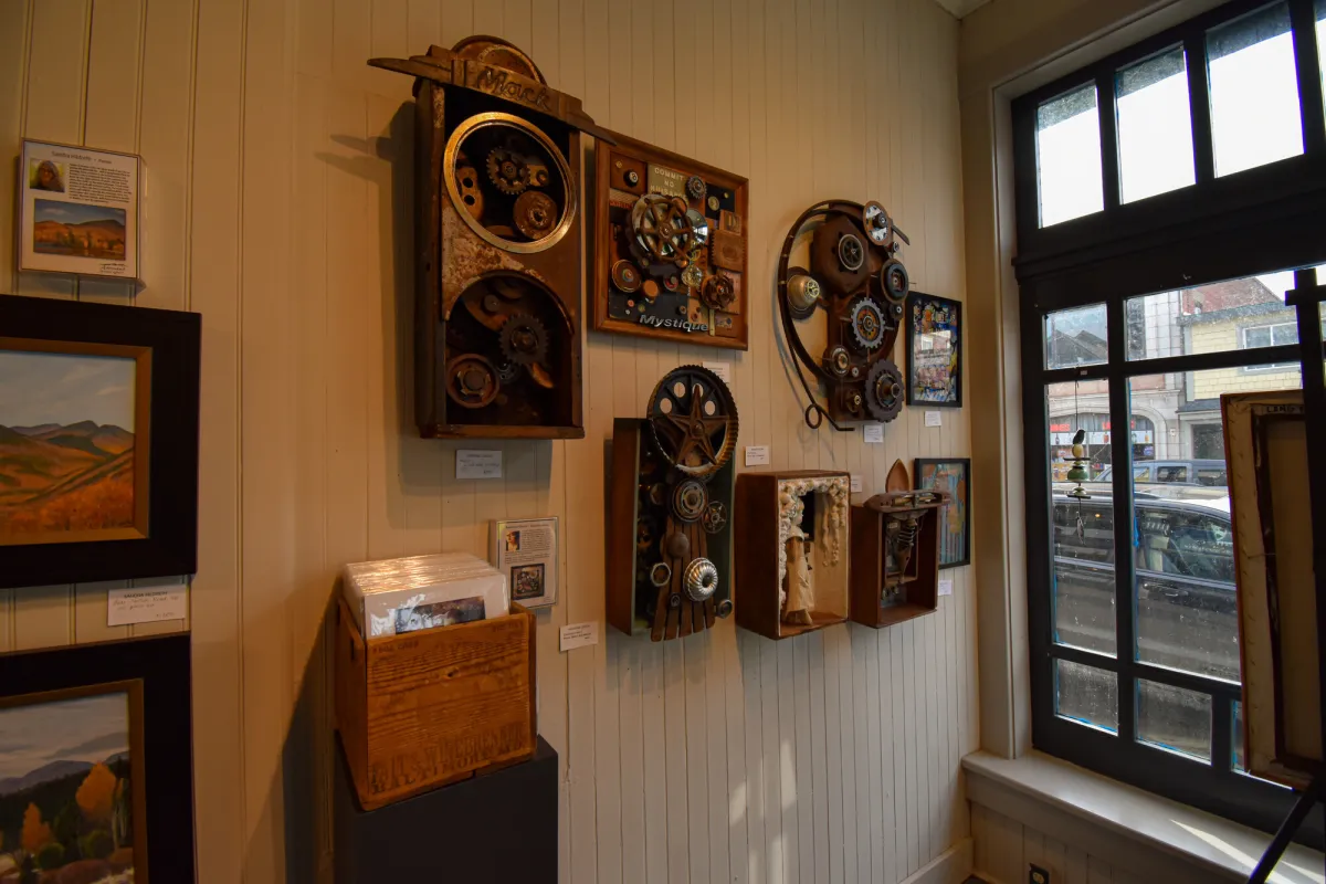 A row of antique clocks on a wall.
