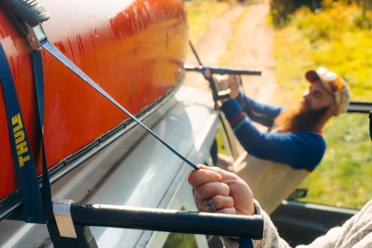 Strapping a canoe to a car.