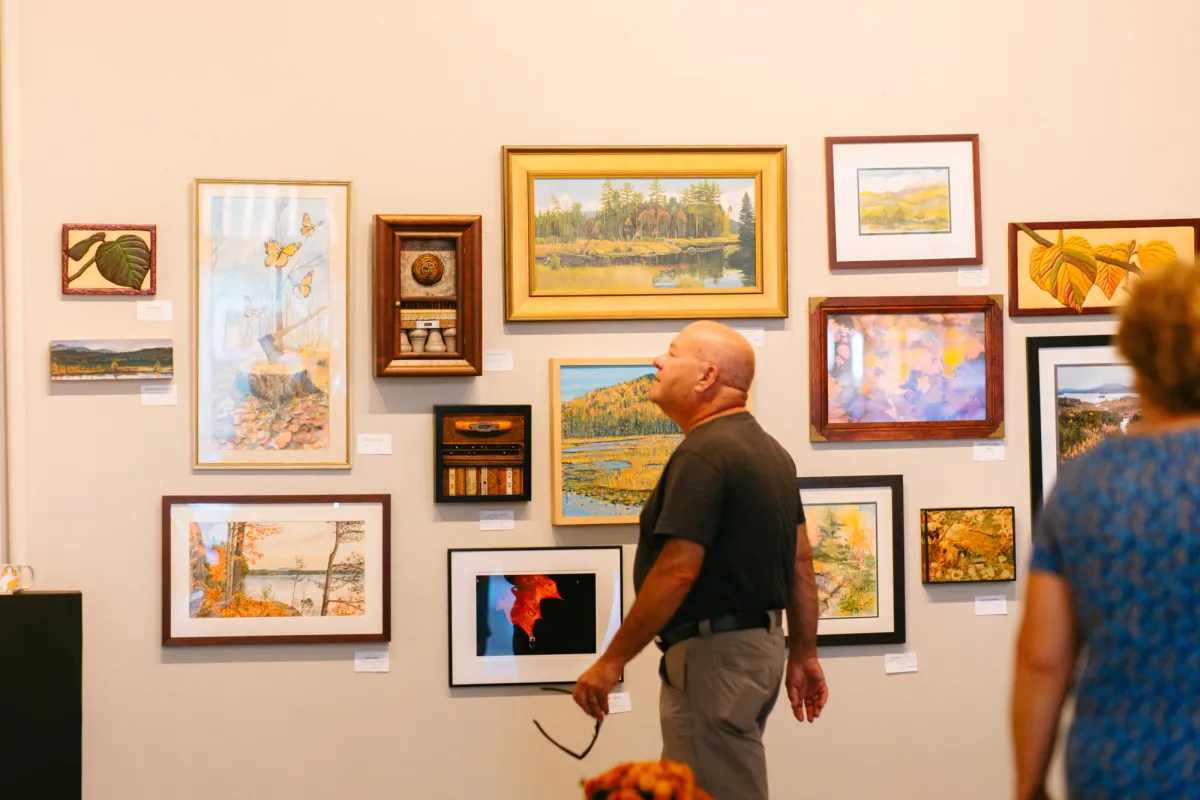 A couple walking through an art gallery.