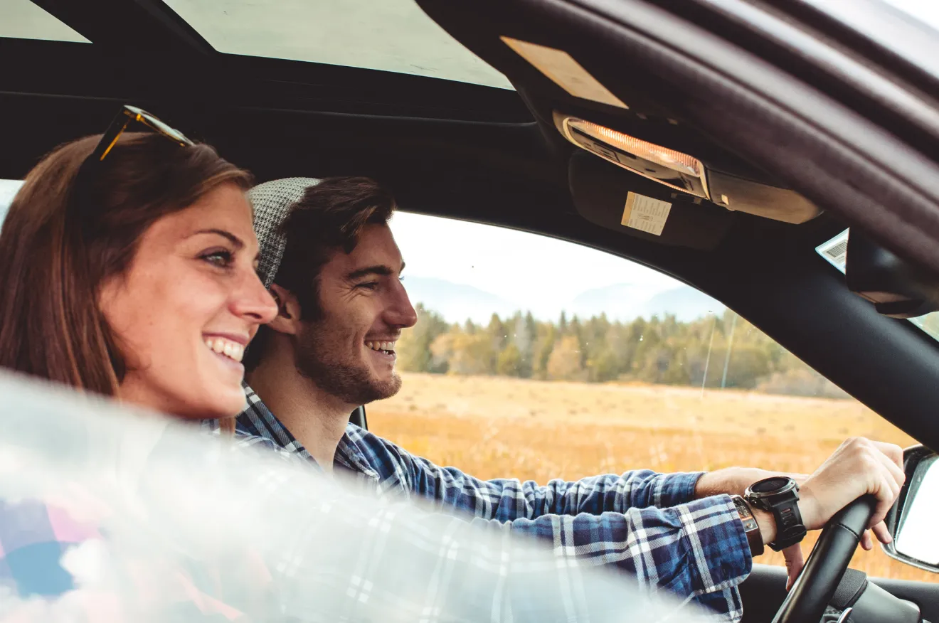 A couple driving in a car.