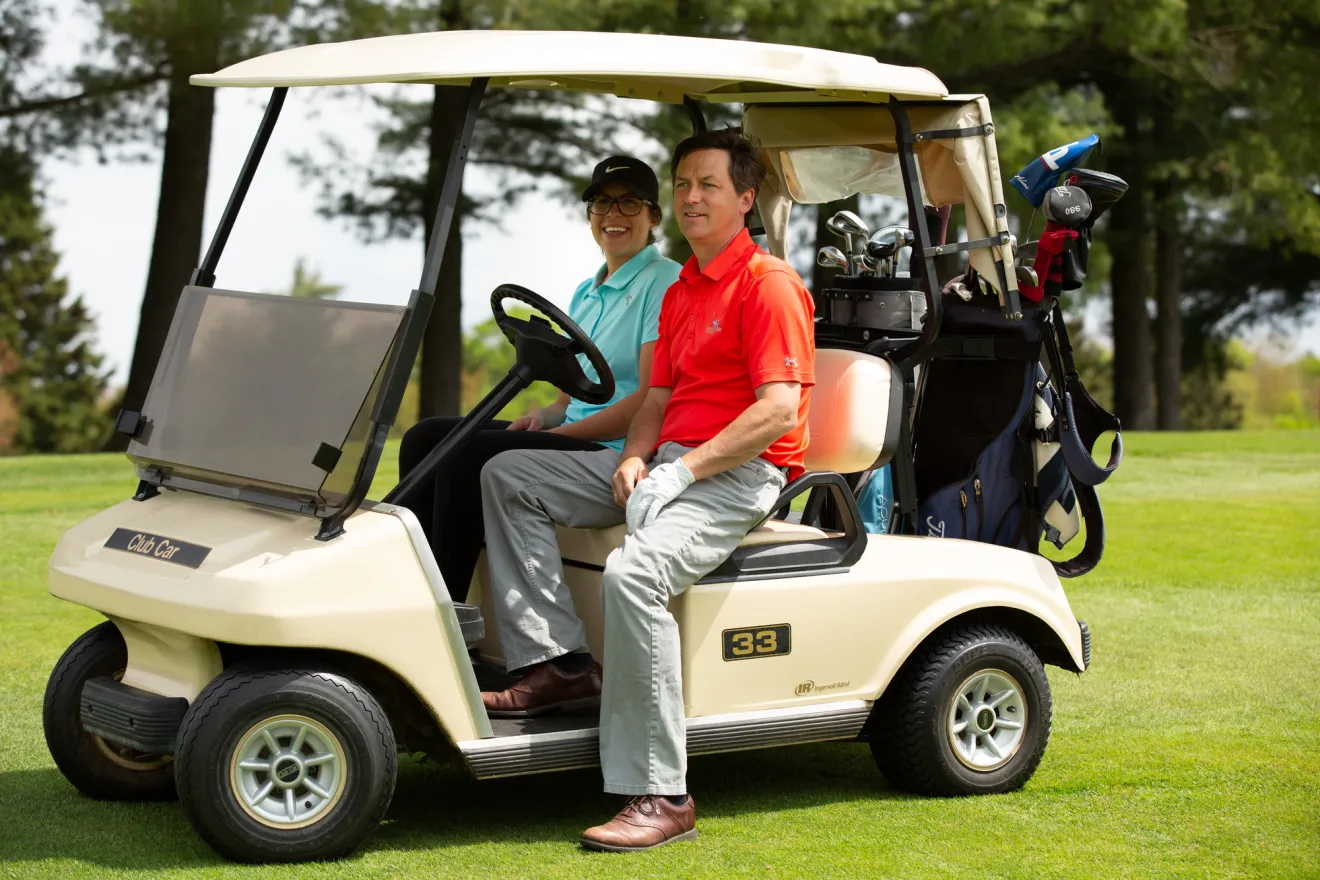 A couple golfing in Saranac Lake.