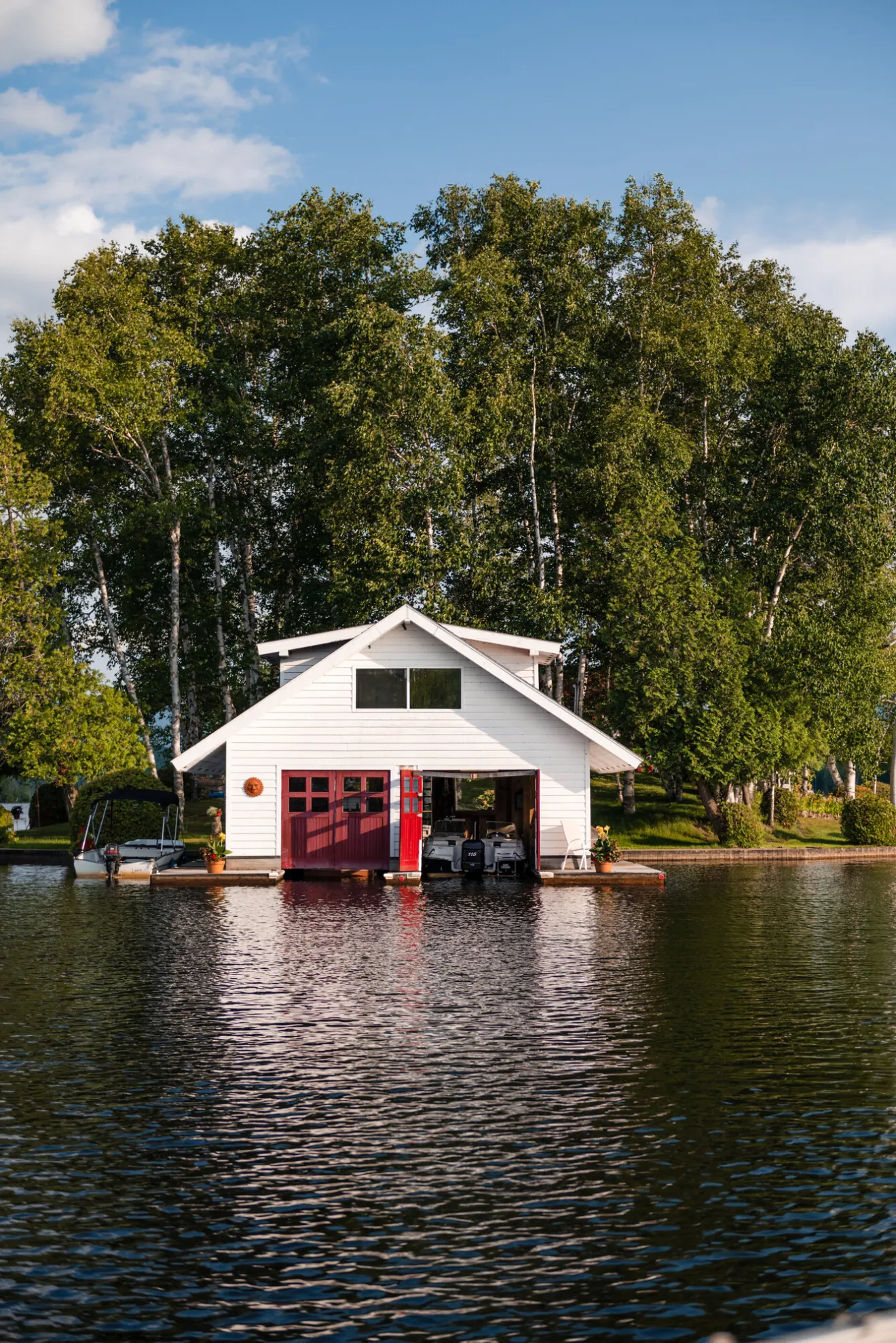A boathouse and cabin on a calm lake offers an inviting destination.